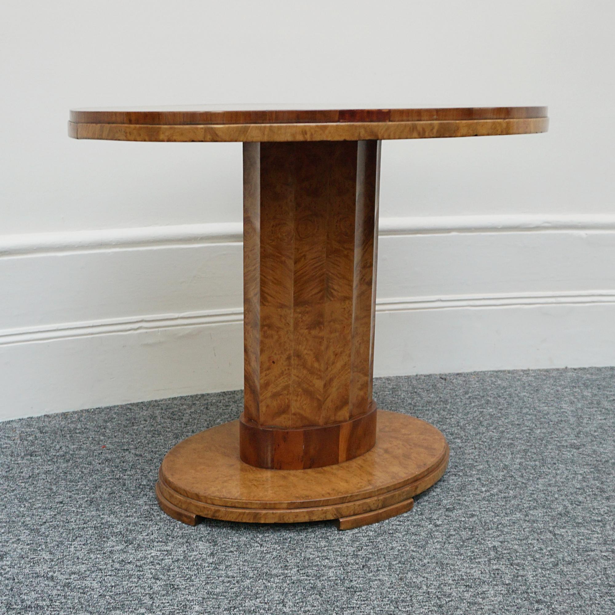 An Art Deco centre table by Harry & Lou Epstein. Veneered walnut oval table with fluted central column set over an oval, stepped base. Elm Banding to bottom of stem. 

Dimensions: H 74.5cm W 91cm D 73cm

Origin: English

Date: Circa 1935

Item No: