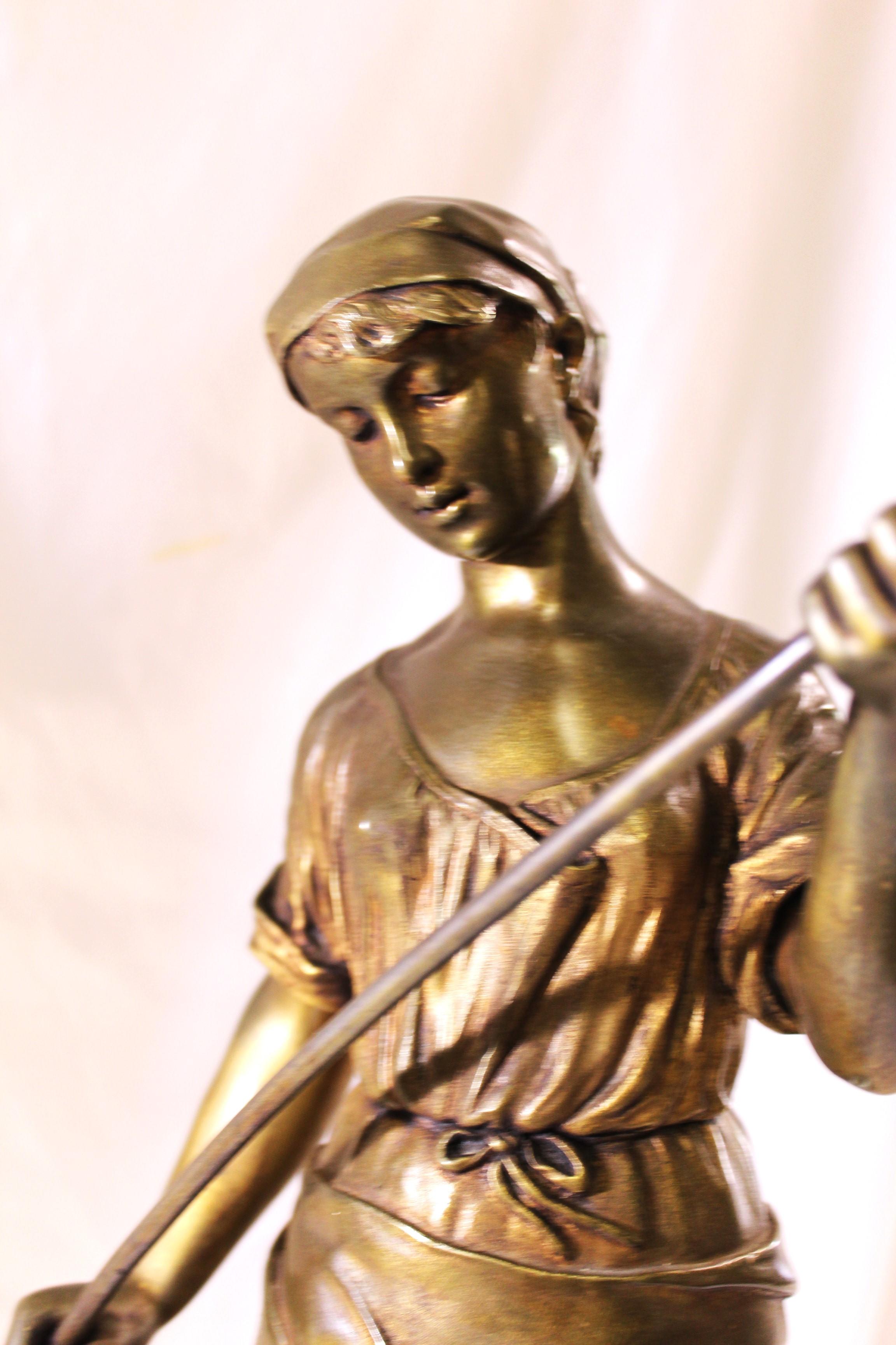 A very fine casting with lots of details showing the little boy's fear of falling off . Holding tight to his mothers dress . Looks like it was gold gilded .  Has the Artist signature on the round part of the base . See details in the photos .