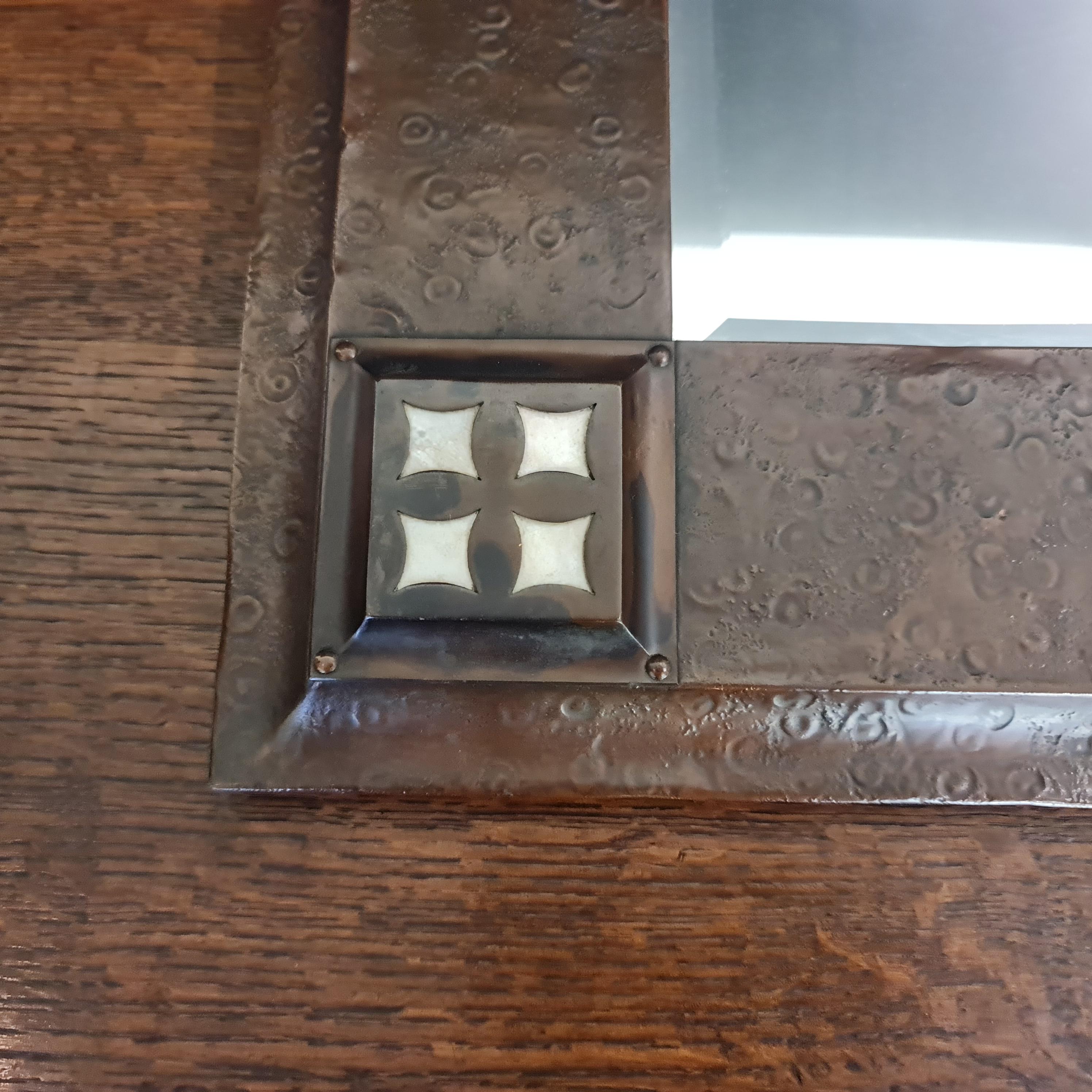 Original Arts & Crafts Movement rectangular copper and mother of pearl mirror circa 1900. This mirror is in excellent completely original condition with it's bevelled plate which is still bright and clear and perfectly useable.