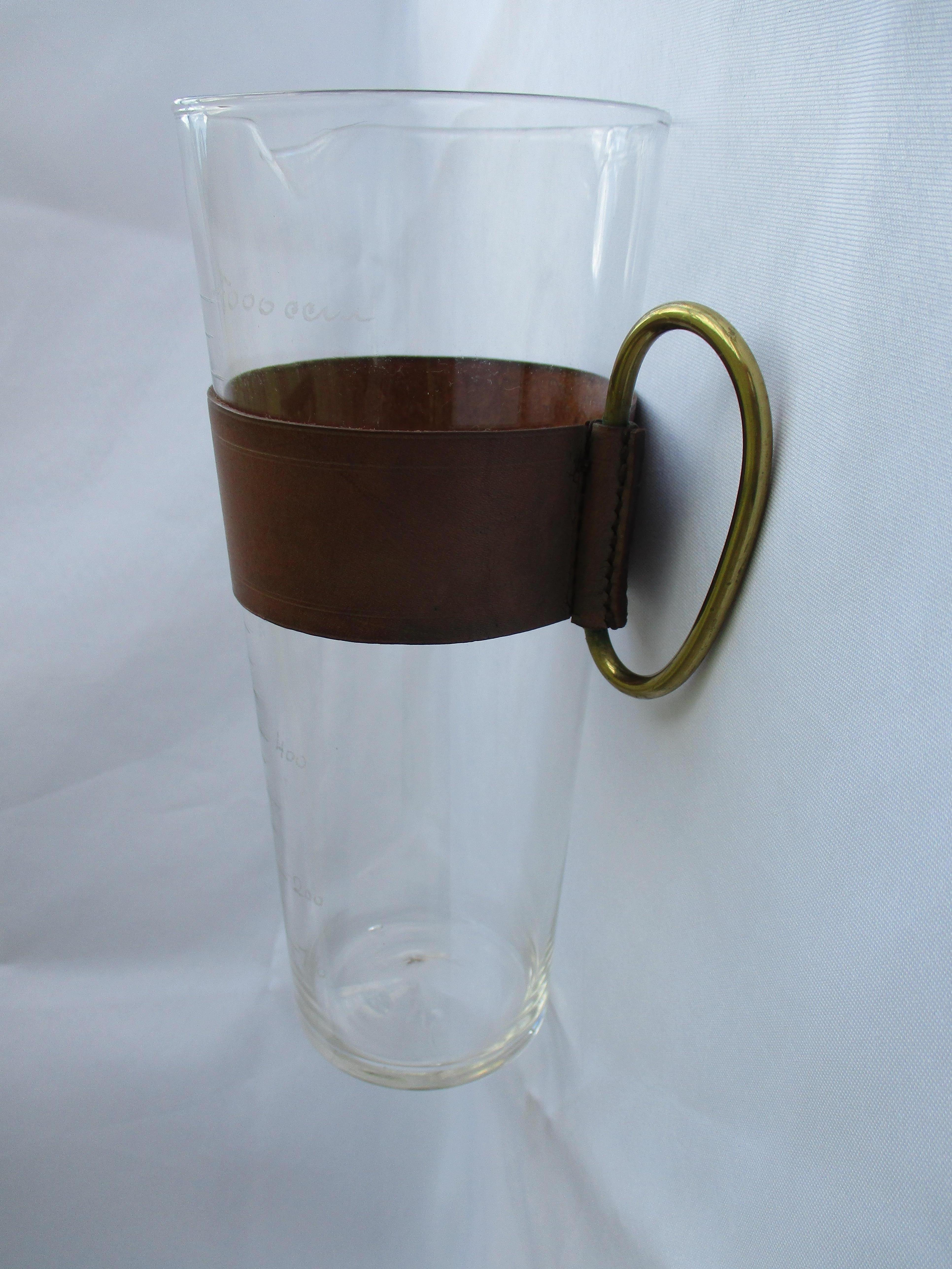 Austrian Original Aubock glass carafe with a leather cuff and brass handle For Sale