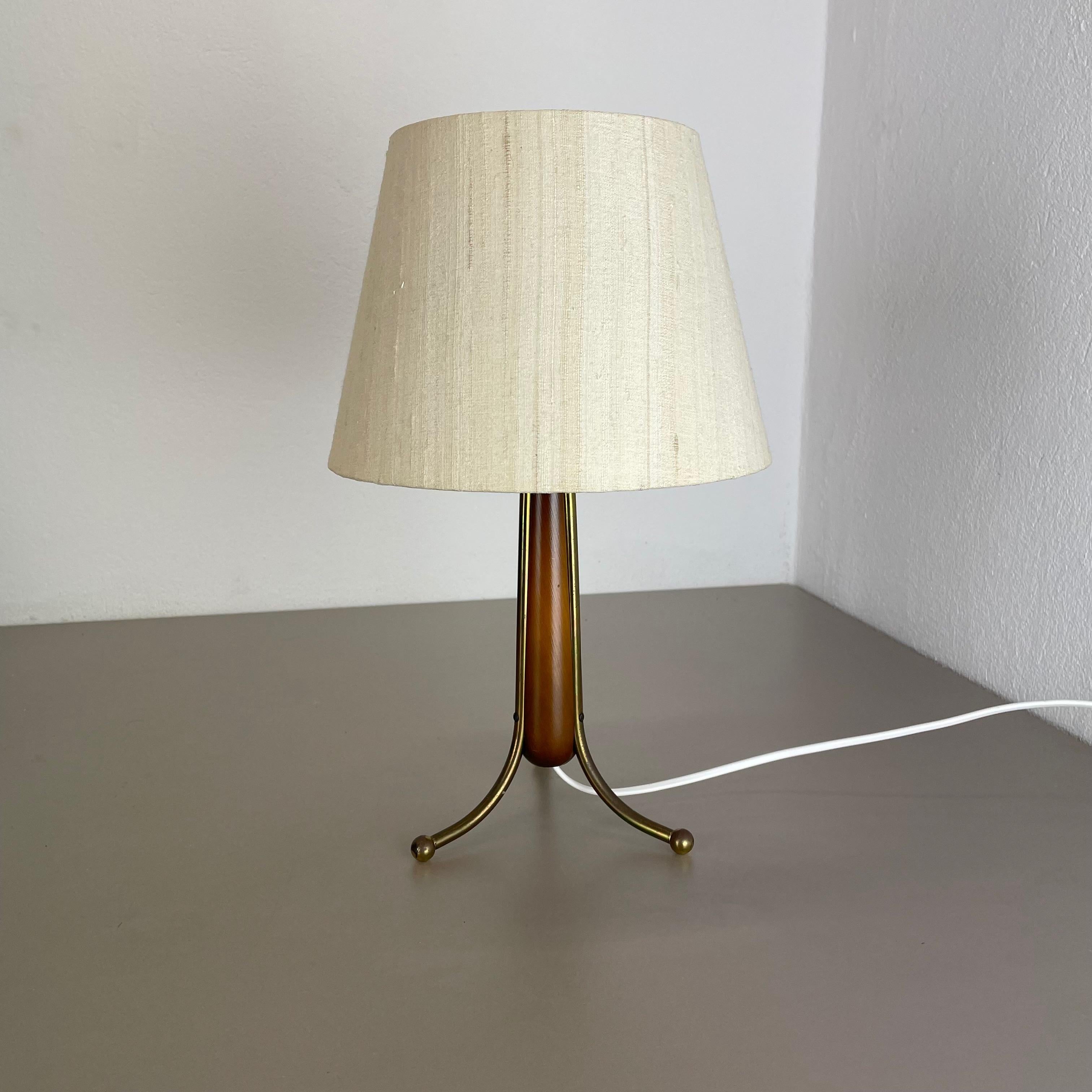 Article:

tripod table light


Origin:

Austria


Age:

1960s


This original vintage tripod table light was designed and produced in the 1960s in Austria. the super rare and Minimalist tripod Stand element is made of wood and 3 brass