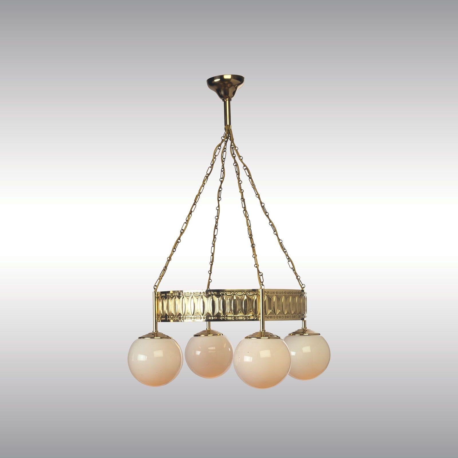 Chandelier with punched secessionist pattern. Handmade with ancient tools, where a plain brass-sheet is slided inch by inch through the punch press. Afterwards the sheet is to align and solded on another brass-sheet to grant solidity. 

Wired for
