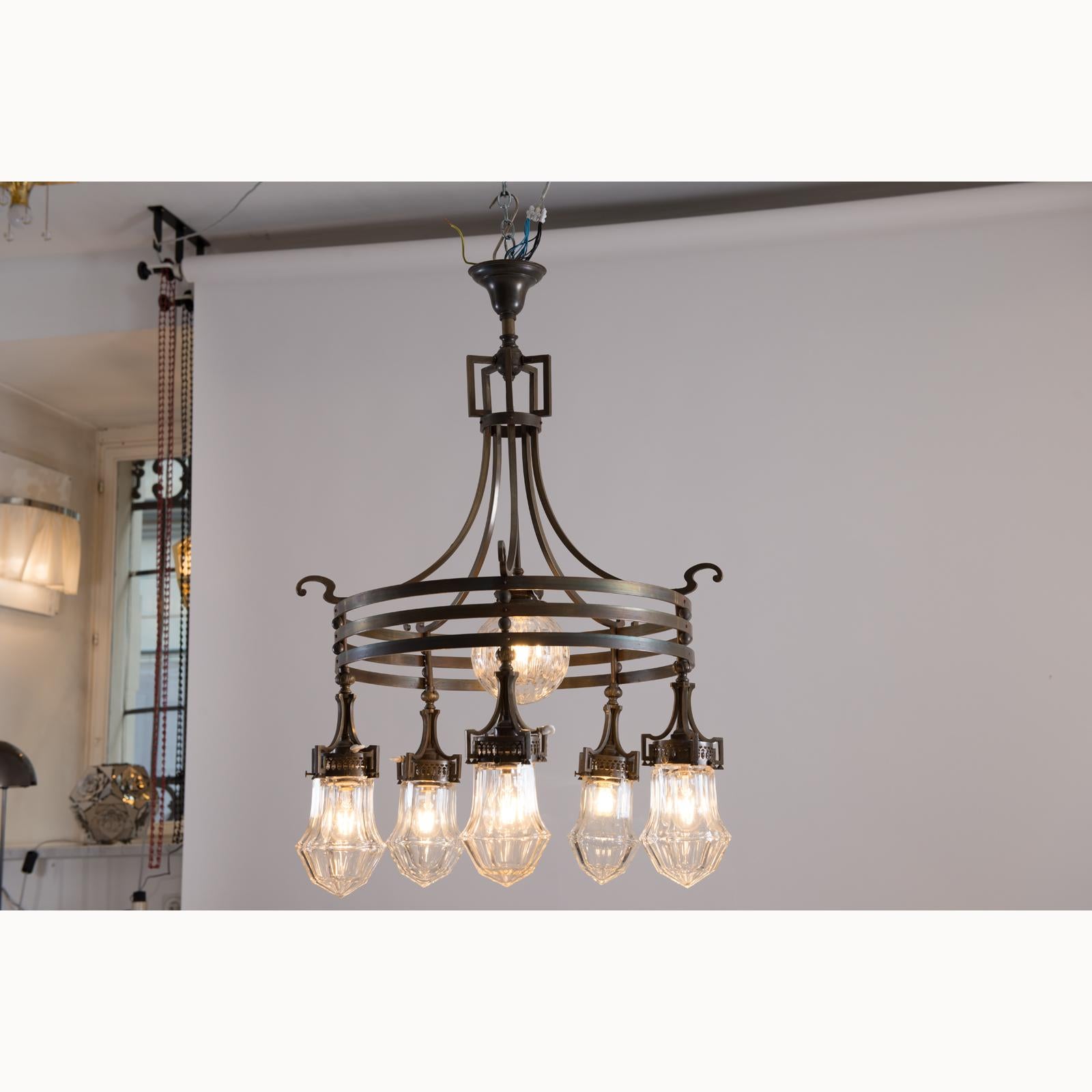 A modernist Jugendstil chandelier with simple ornaments, patinated brass.
Total drop can be customized.
