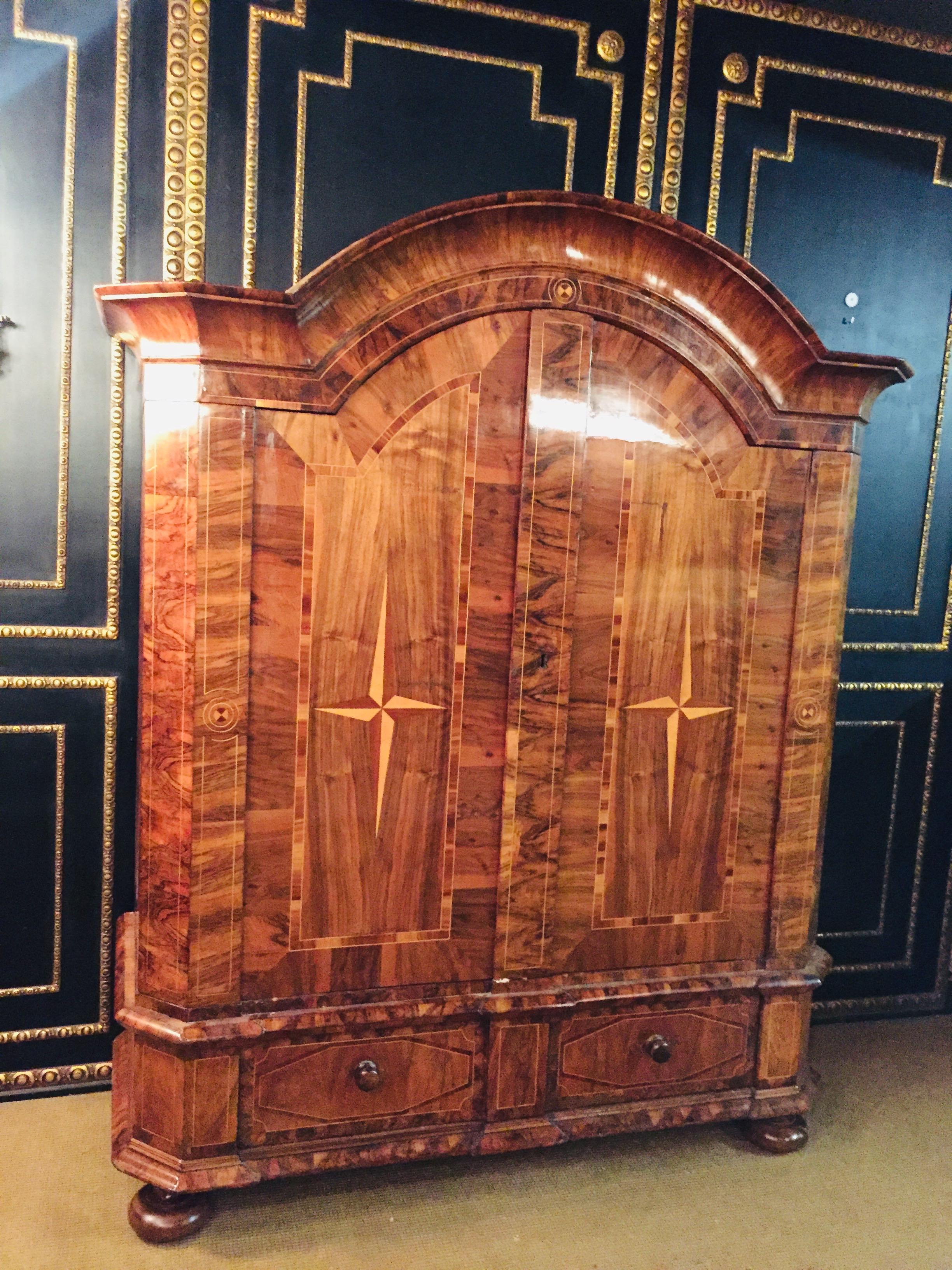 Original baroque cabinet circa 1740 walnut, measures: H. 250 cm x W. 220 cm

Walnut on solid wood. Rectangular body with two doors. Volute-shaped structure. Multiple cranked, profiled cornice.

Unfortunately the lock is missing.

Historical good