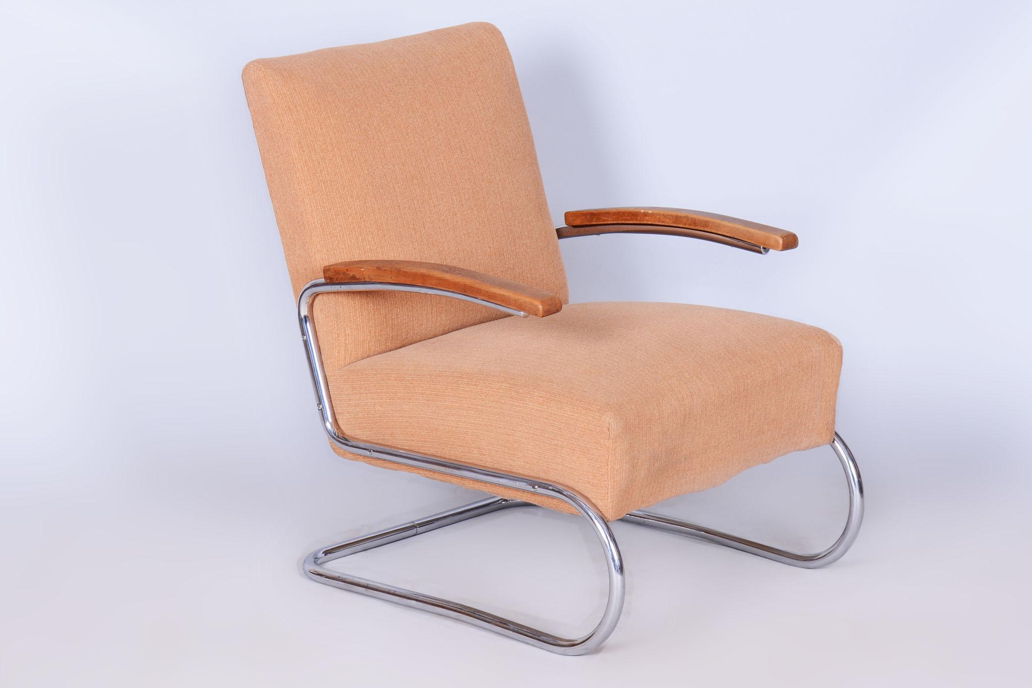This elegant Bauhaus armchair comes from Germany from the first half of the 20th century. It is manufactured by Thonet and impresses with its combination of tubular chromed steel and solid beech armrests. The armchair is in original, very well