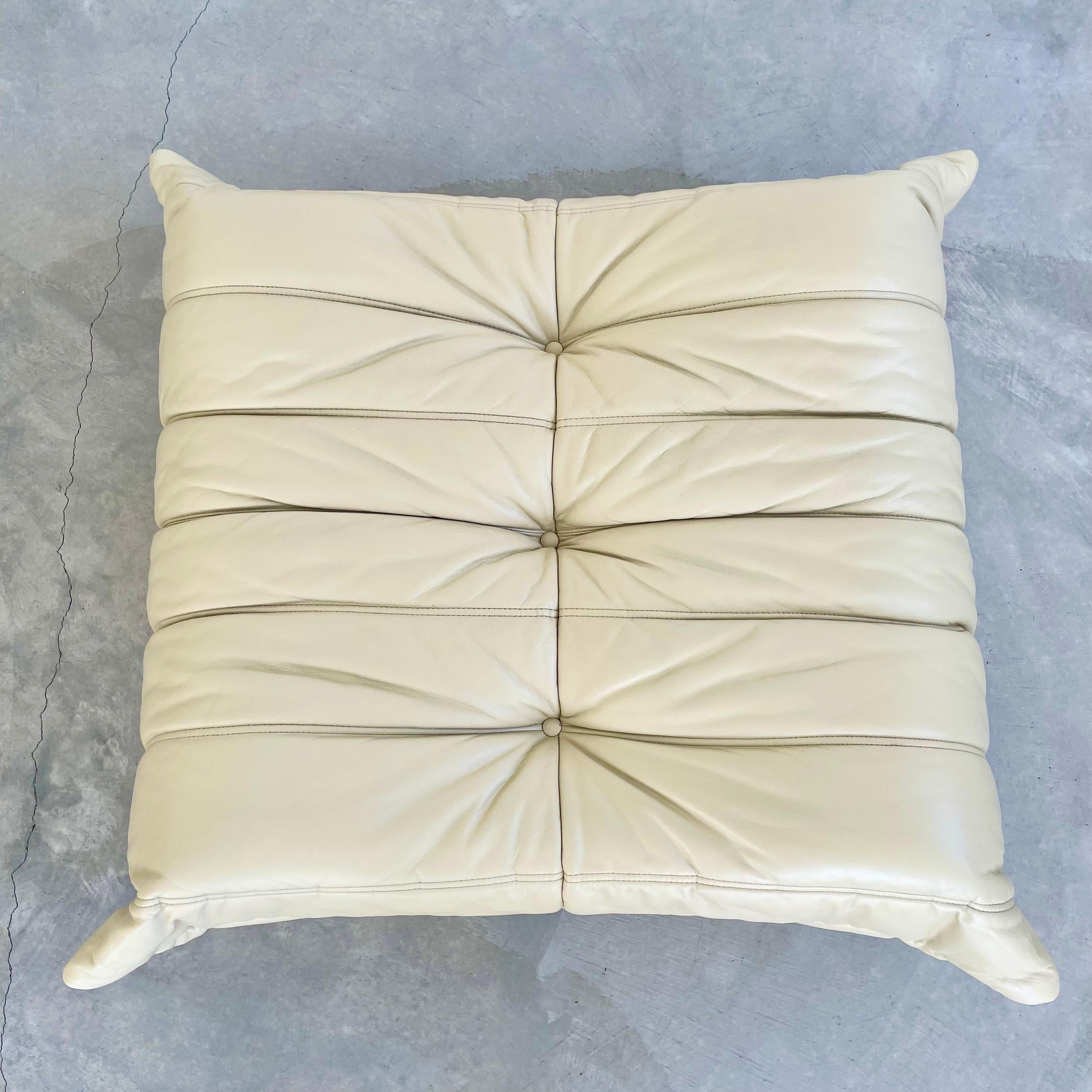 Vintage leather Togo ottoman by Michael Ducaroy for Ligne Roset. Original leather in a beautiful beige color. Comfortable as a footrest or as a seat. Hard to find item. These togo pieces are a perfect addition to any space. Ottoman is in very good