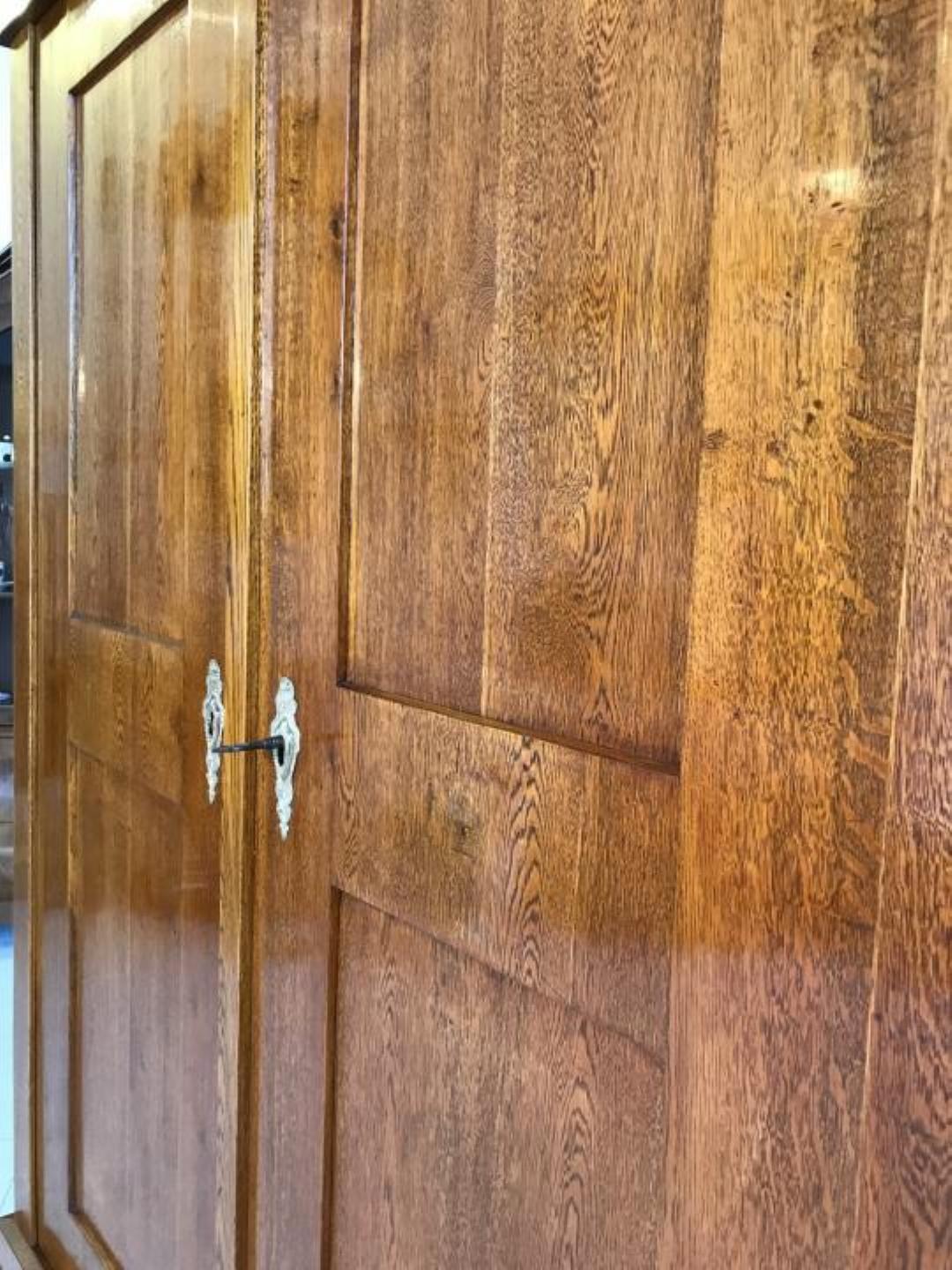 Antique early Biedermeier two-door wardrobe or armoire with a classic design.
Made circa 1810 in Germany out of carefully selected oakwood with a beautiful grain.
This cabinet has been recently restored and polished with shellac, therefore its in