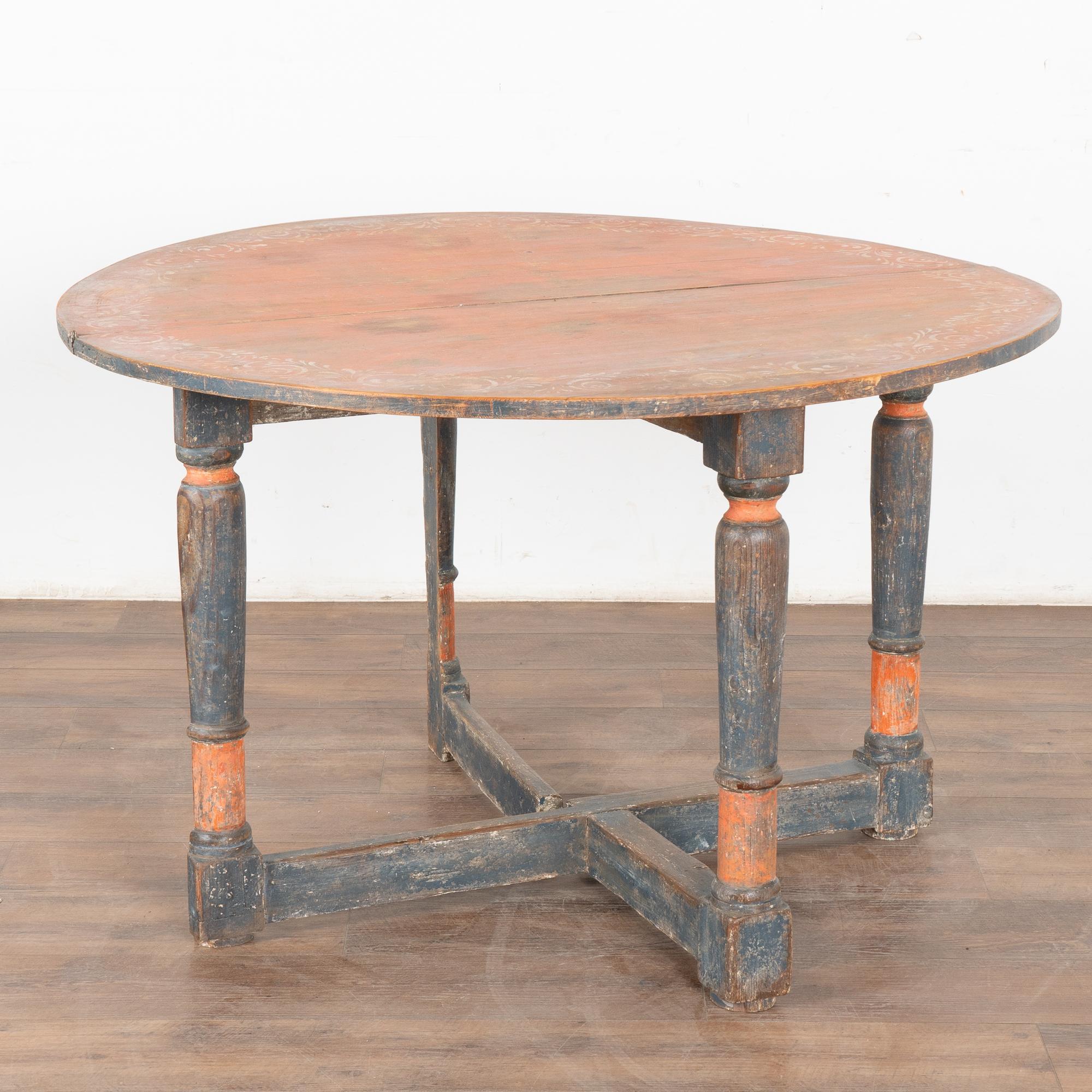 There is wonderful aged charisma to this drop leaf gate leg table that can serve as a side table, demi-lune console or even kitchen table.
To find an original painted table such as this one is a special find. Note the blue and red paint (with