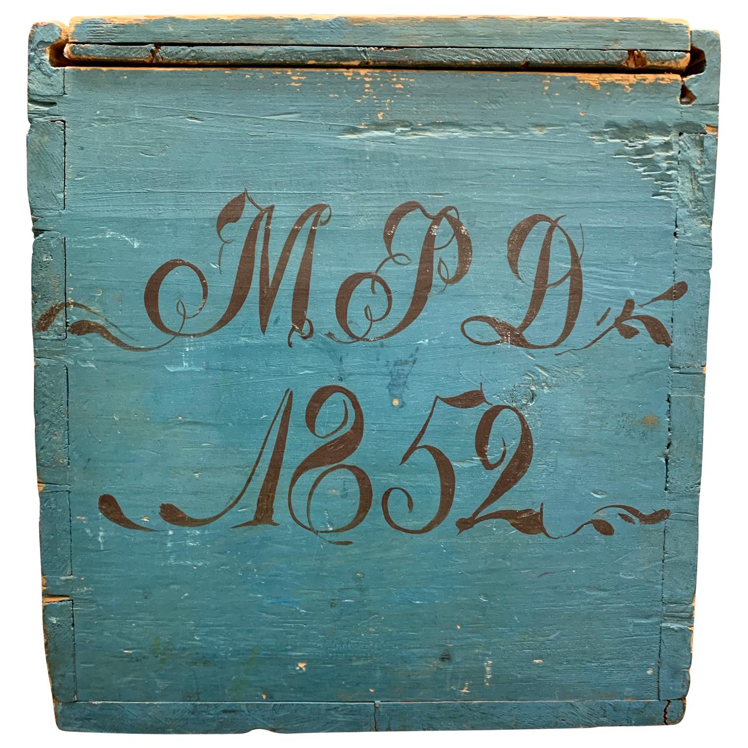 An original blue and red painted Swedish Folk Art wooden box dated 1852. Signed MPD where the D stands for 