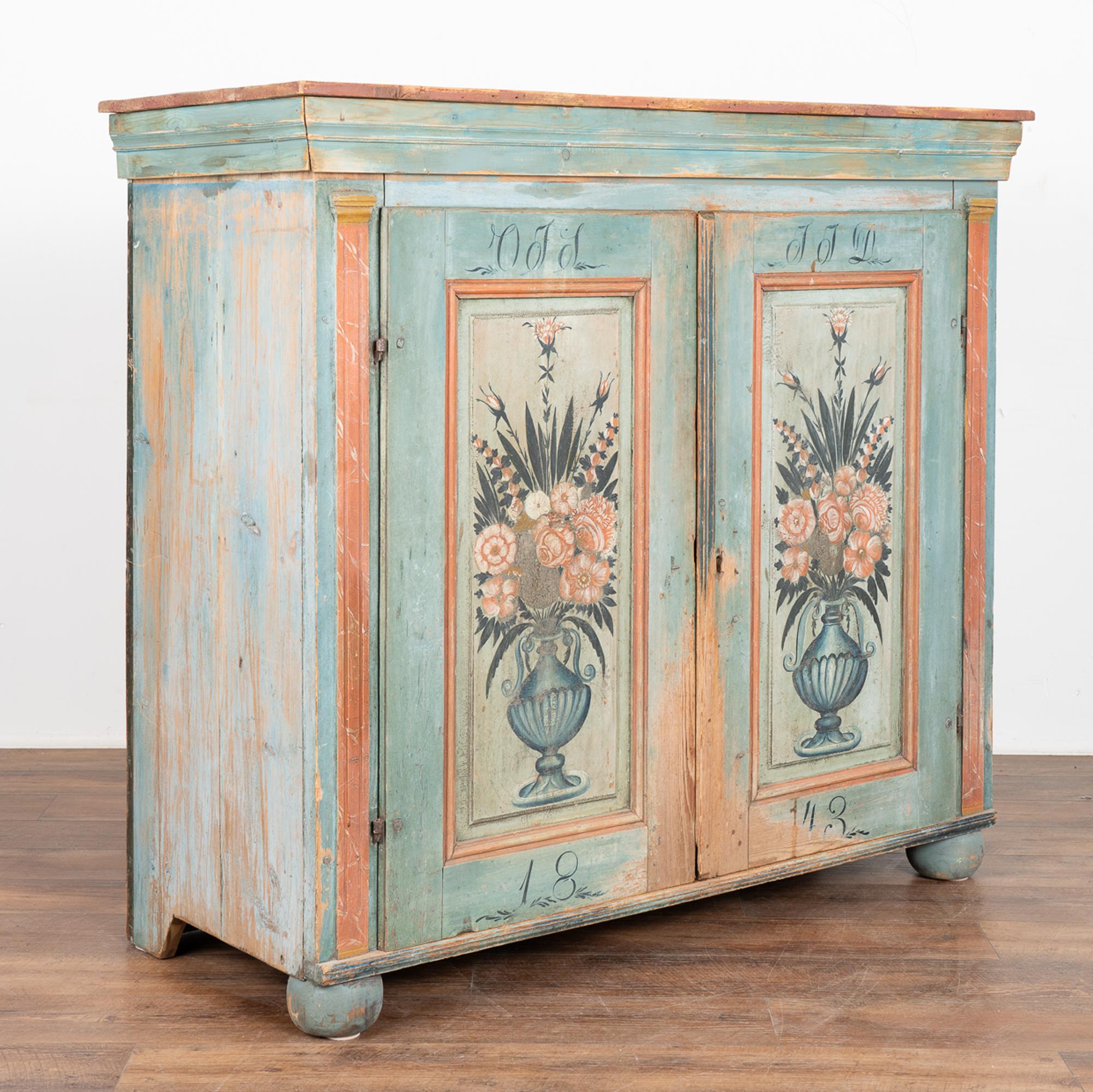 While you can frequently find original painted Swedish trunks, it is difficult to find a cabinet or sideboard with exceptional original folk art paint such as this one.
The two panel doors are painted with a traditional floral/vase motif against a