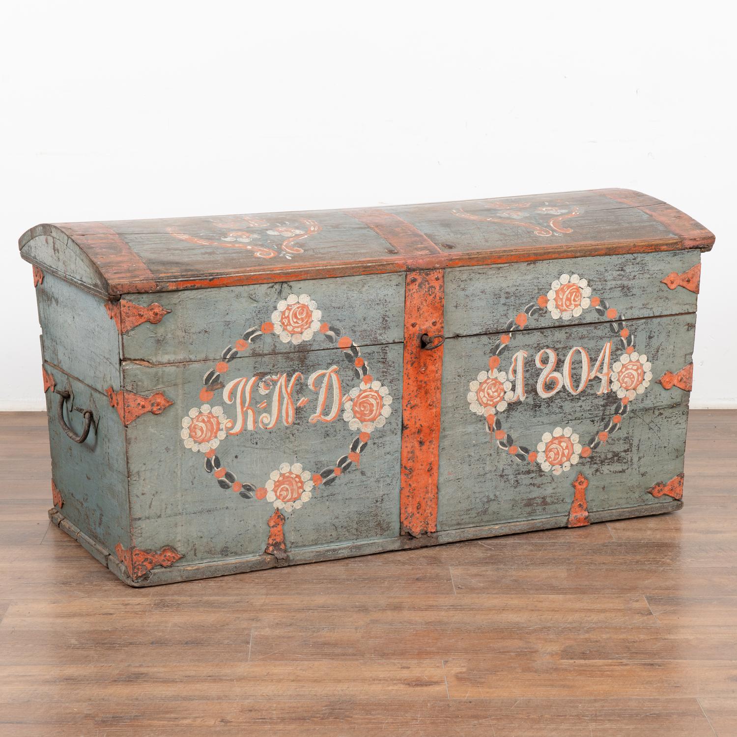 Original blue painted dome top oak trunk from Sweden with traditional hand-painted details include floral motif along top and front.
Monogram of KND and date 