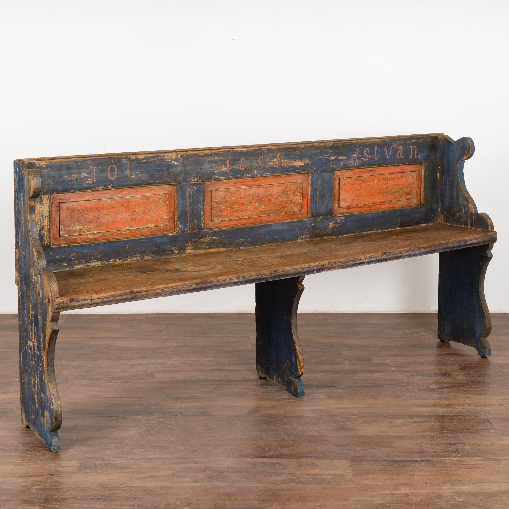 This narrow bench is a fun find due to its unique smaller scale and at just over 6' long, perfect for a small mud room, entryway or hallway.
Original hand painted details include red panels against the blue background, date of 1885 along the back.