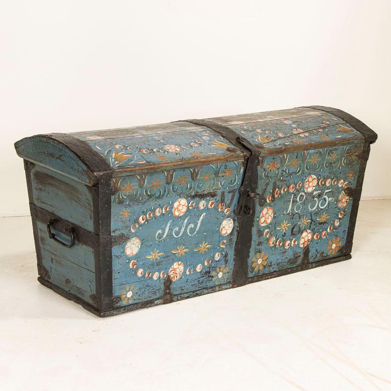 The soft blue paint is all original on this lovely dome top trunk from Sweden. The monogram and date of 1835 are painted on the front indicating it was likely a wedding present for a couple begining their life together. Unique to this trunk is also