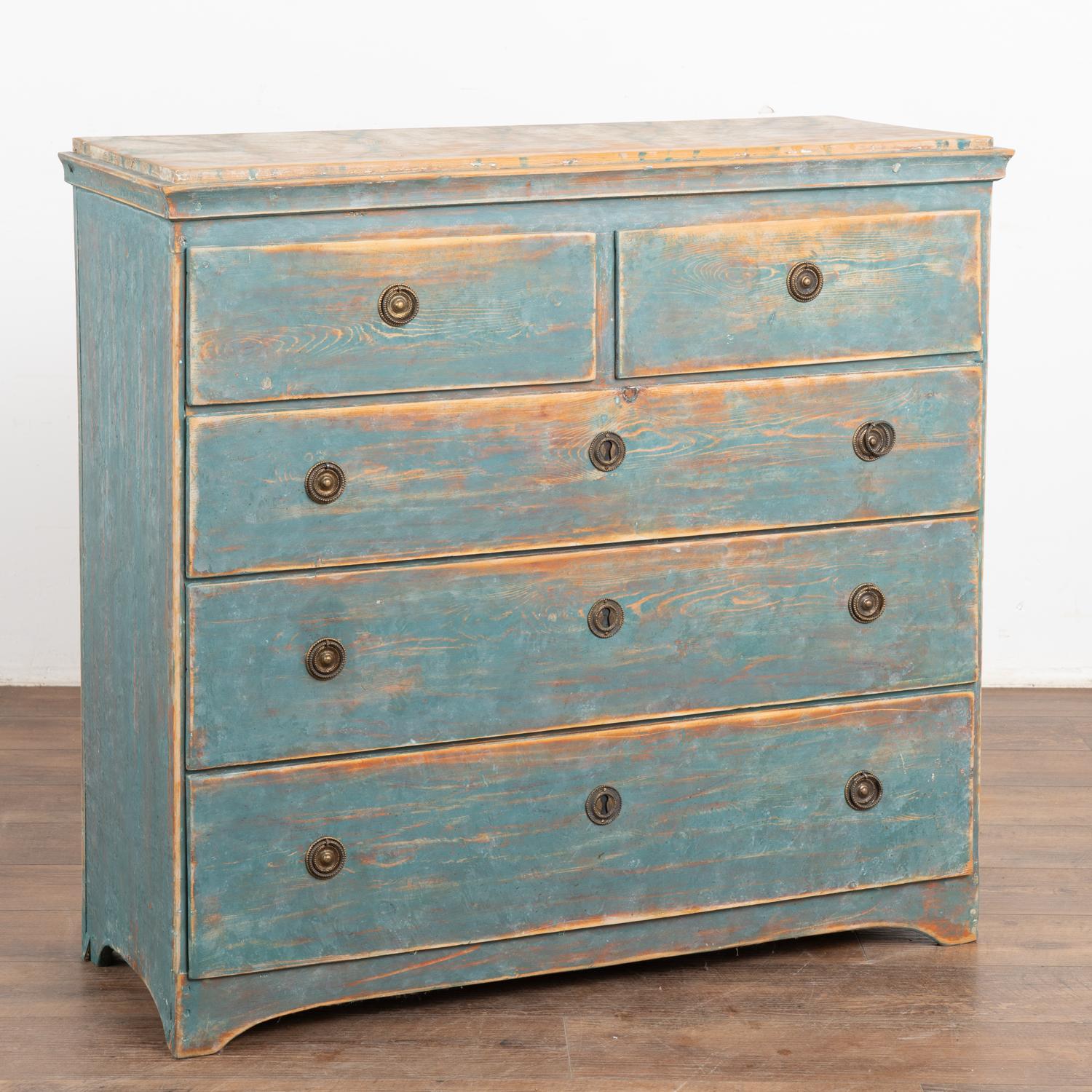 Original blue painted chest of drawers with warm, aged patina. The paint has been worn down through generations of use, revealing the natural pine below.
Note photos of top with traditional faux marble painted finish; much of pine shows along the