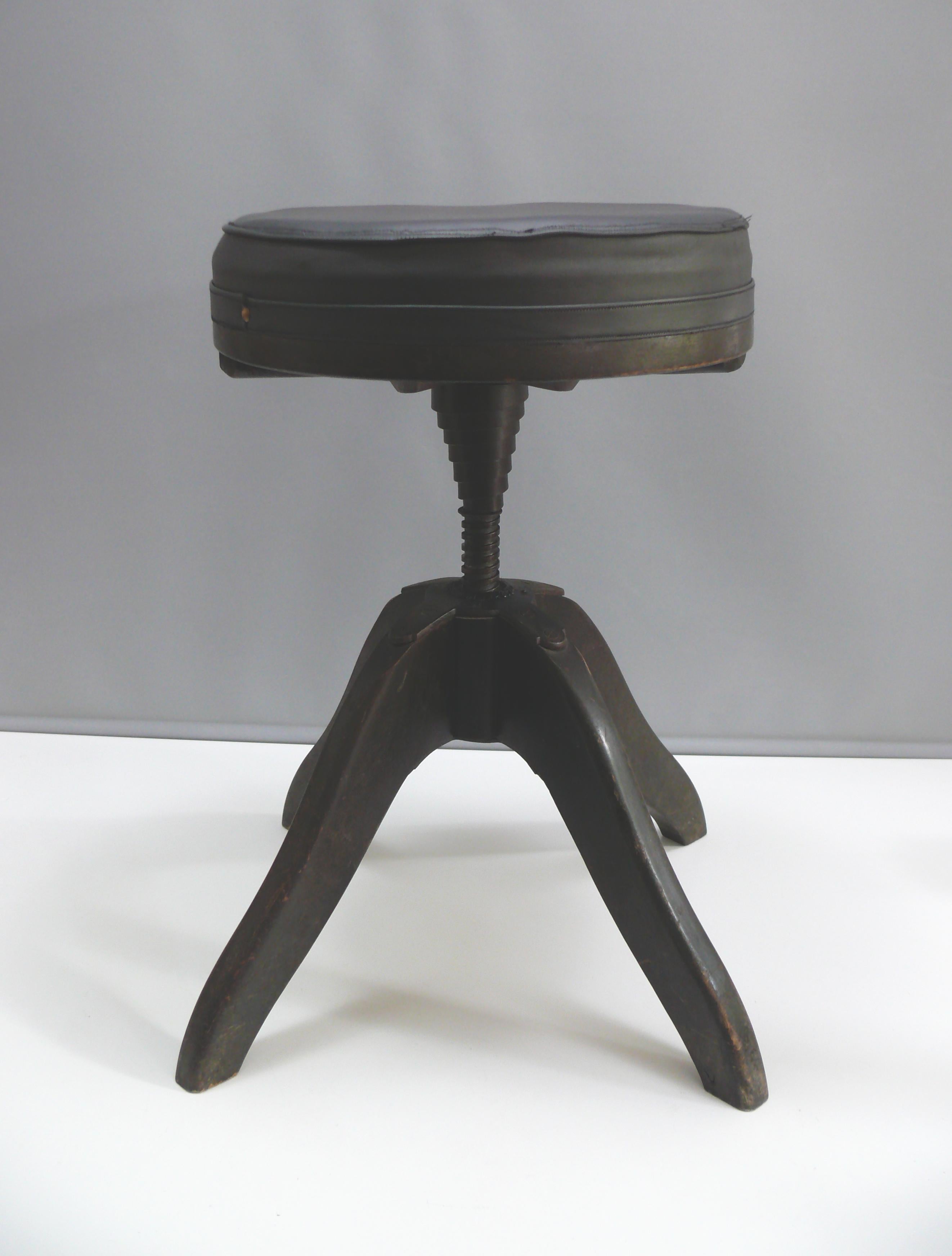 A black, upholstered, and sprung swivel stool from the mid-20th century by Stoelcker KG, Ettenheim, known under the name 