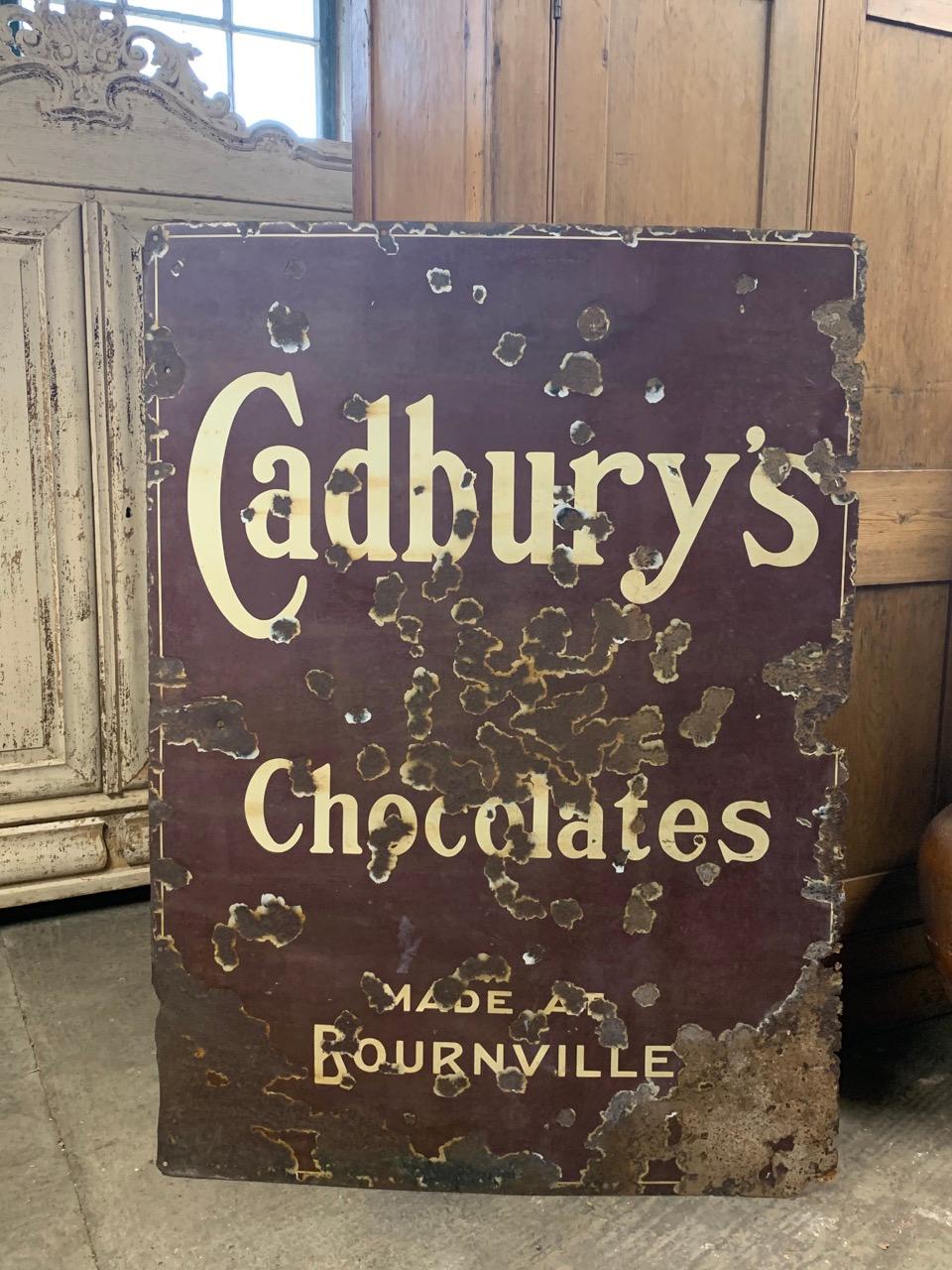 An original early 20th century enamelled sign advertising Cadbury's Chocolate Made At Bournville. Circa 1920's. In distressed condition but a good size and rare colour.