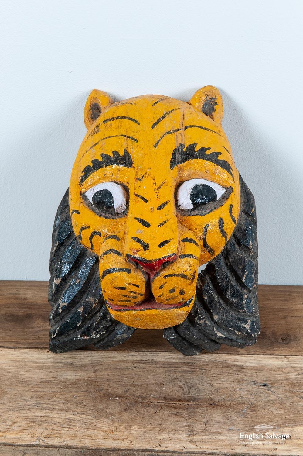 Brightly painted carved wooden vintage Indian tiger mask. Used in festivals / melas for re-enactments and also reputedly wearing a tiger mask on the back of one's head will deter a tiger sneaking up from behind to attack! Some marks and scuffs