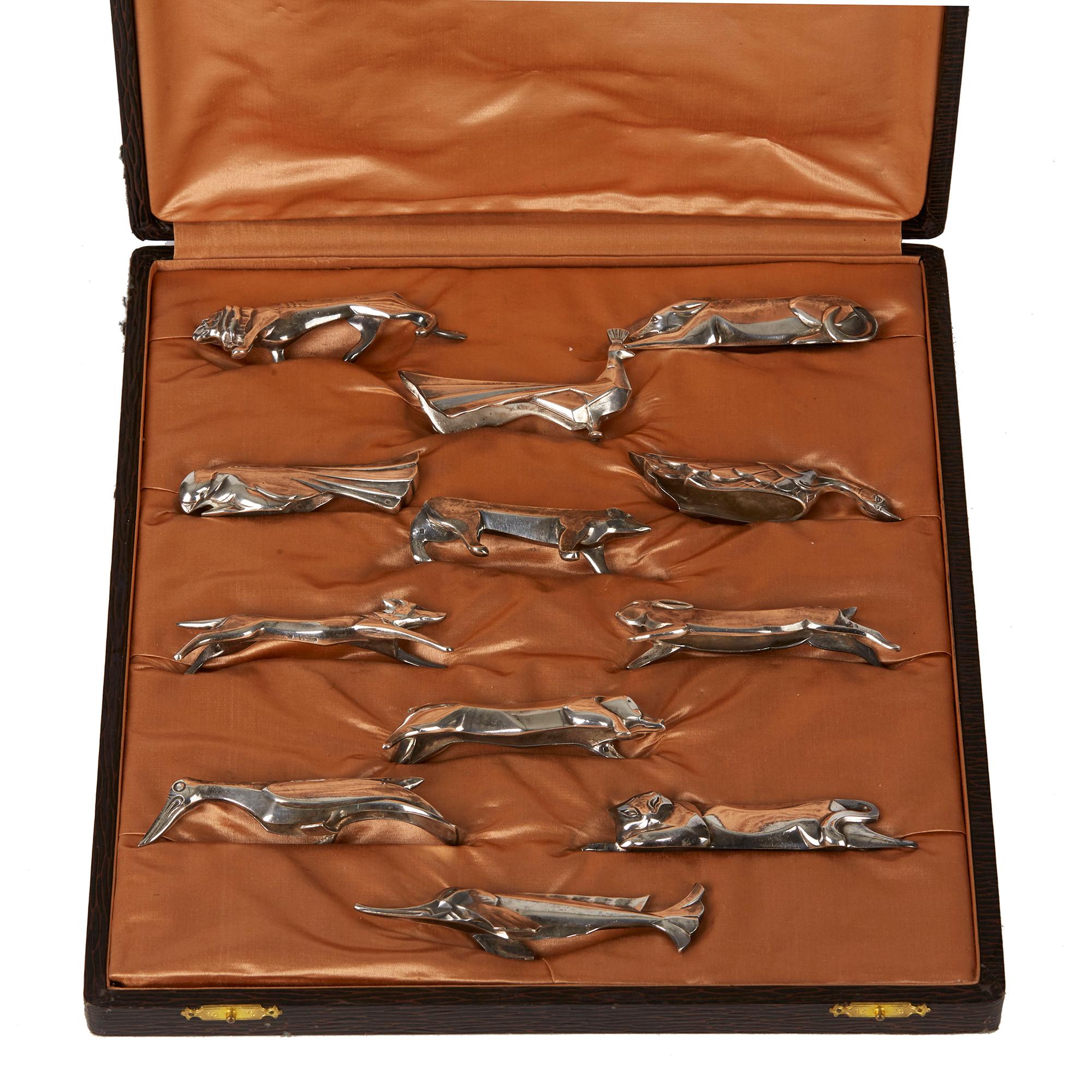 A fine original boxed collection twelve Art Deco French silver plated animal knife rests designed by Marcel Eduoard Sandoz each representing a different animal or fish. The quality and heavily made knife rests are made by Gallia Christofle