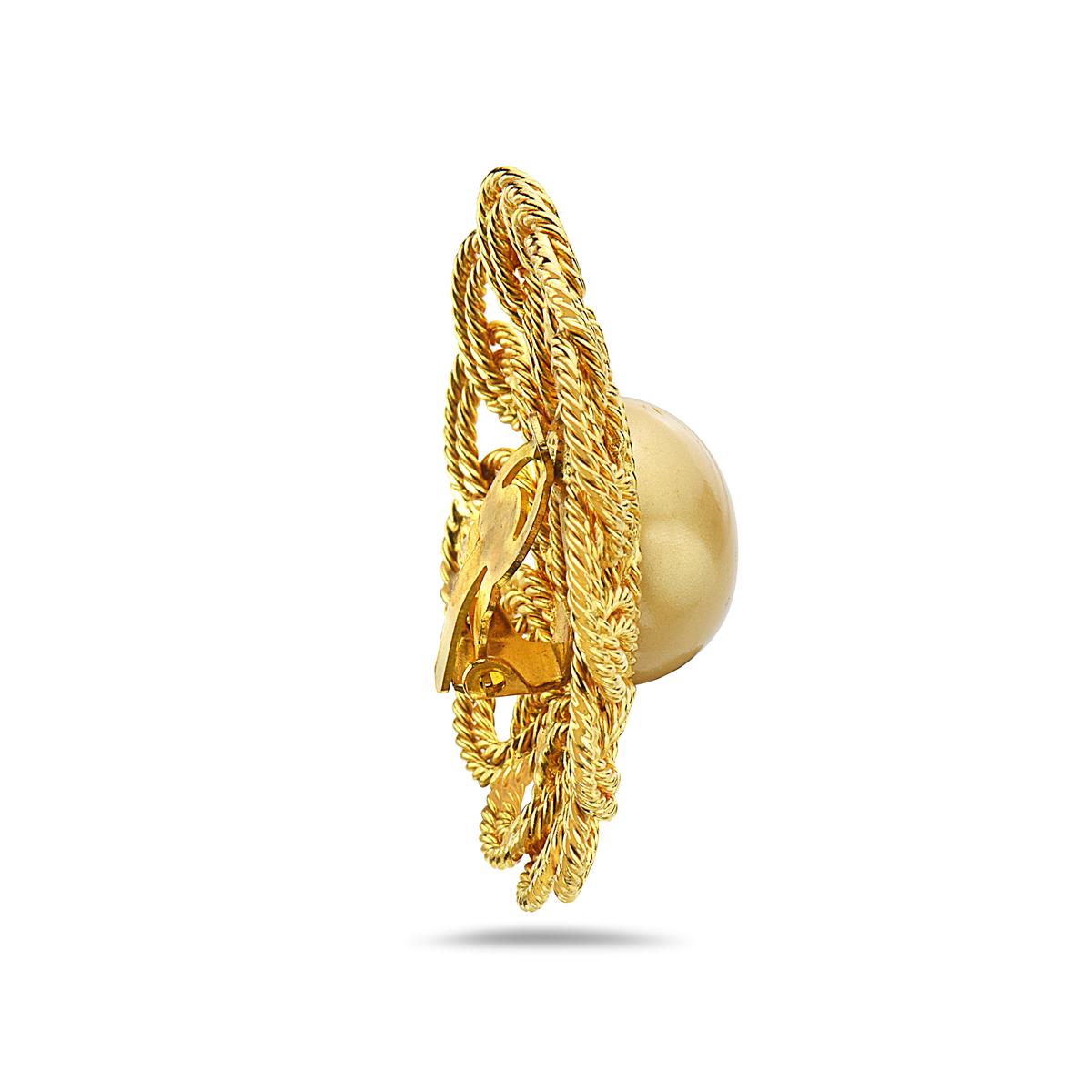 These original Chanel vintage statement ear clips feature a gold color pearl measuring 18.44mm surrounded by double cc rope design. 40.6 grams total weight.  