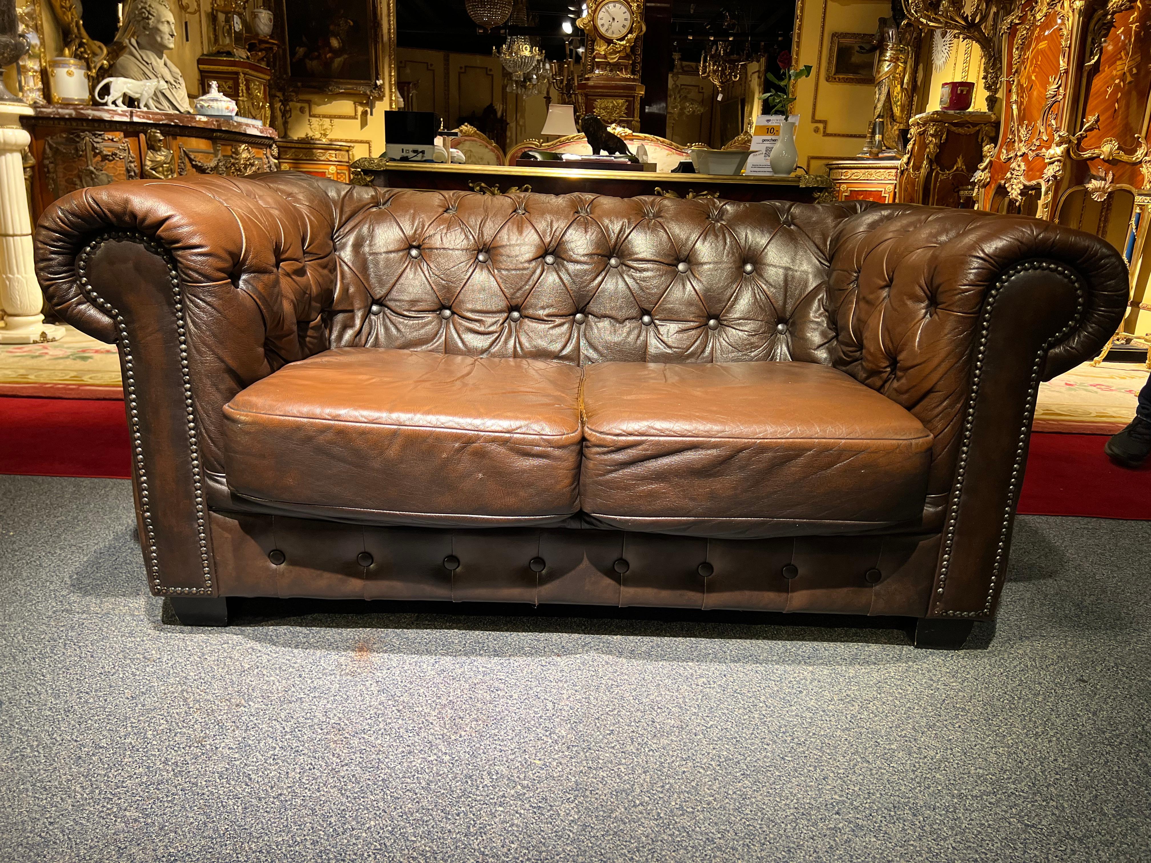 We are delighted to offer this stunning rare handmade in England brown leather two-seat Sofa. Where to begin! This sofa is absolute eye candy from every angle, it has the original leather hide, it has been hand dyed this lovely and bespoke brown