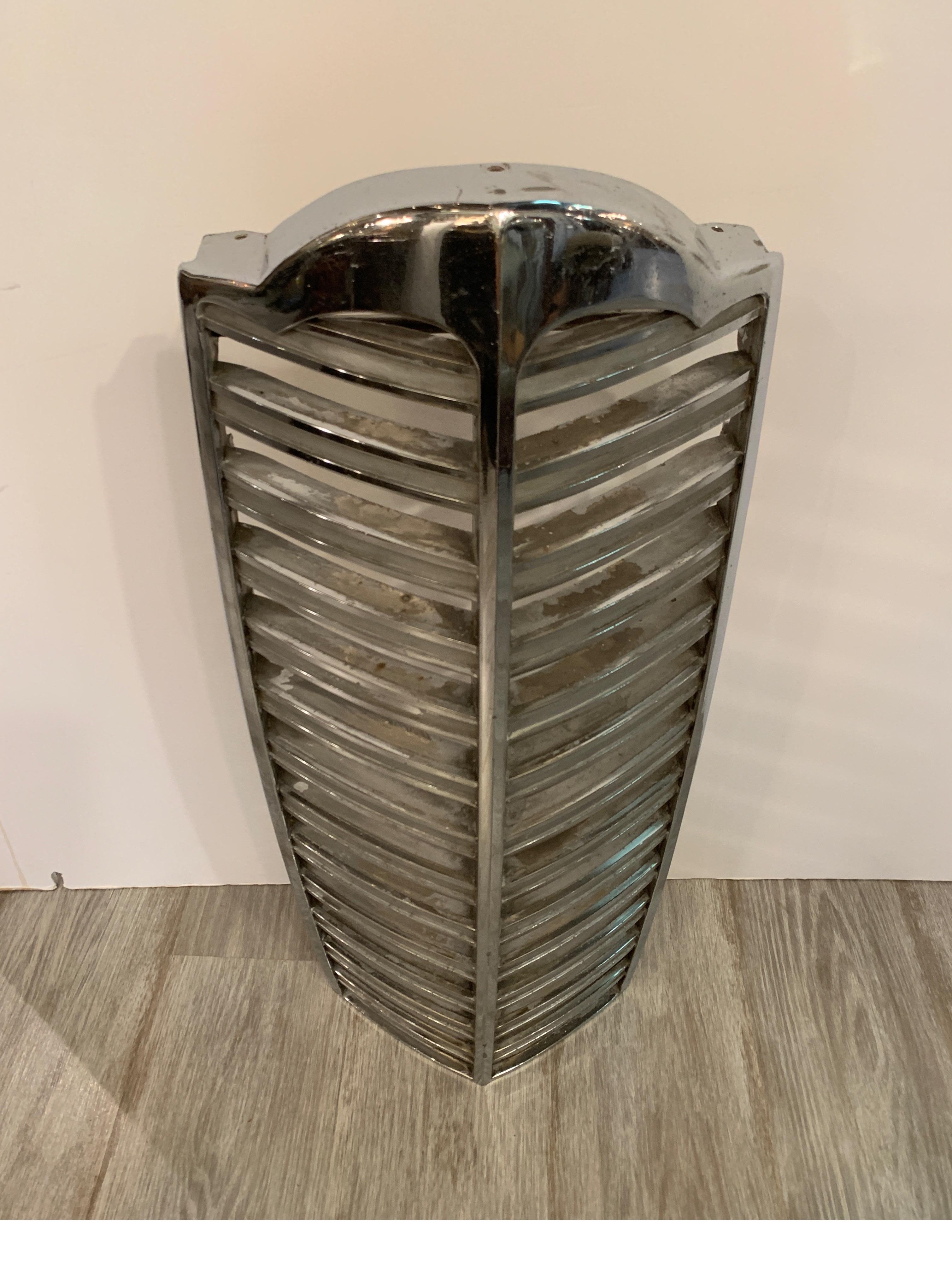 Unusual original chromed grill from a Packard car. The heyday of Detroit, the Packard was an exceptional and classy vehicle. The classic piece is mounted on a custom base without any modifications to the original grill. A beautiful grill which shows
