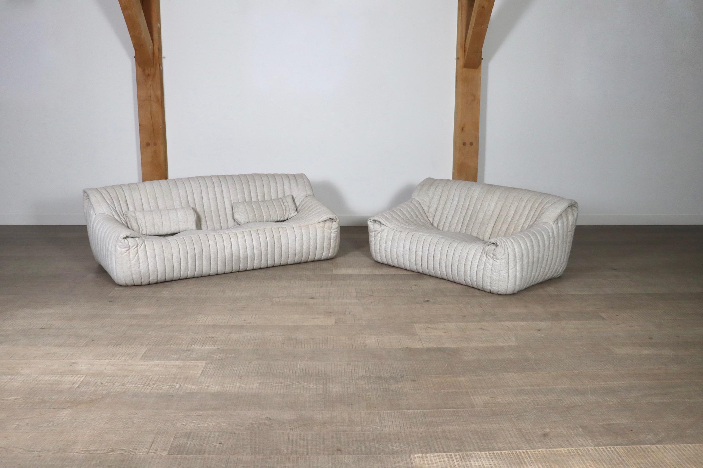 Beautiful original three seater and two seater sofa in an off-white textured upholstery, by Annie Hieronimus for Cinna, a division of Ligne Roset, France 1970s. This incredibly comfortable, yet lightweight design will instantly bring character to