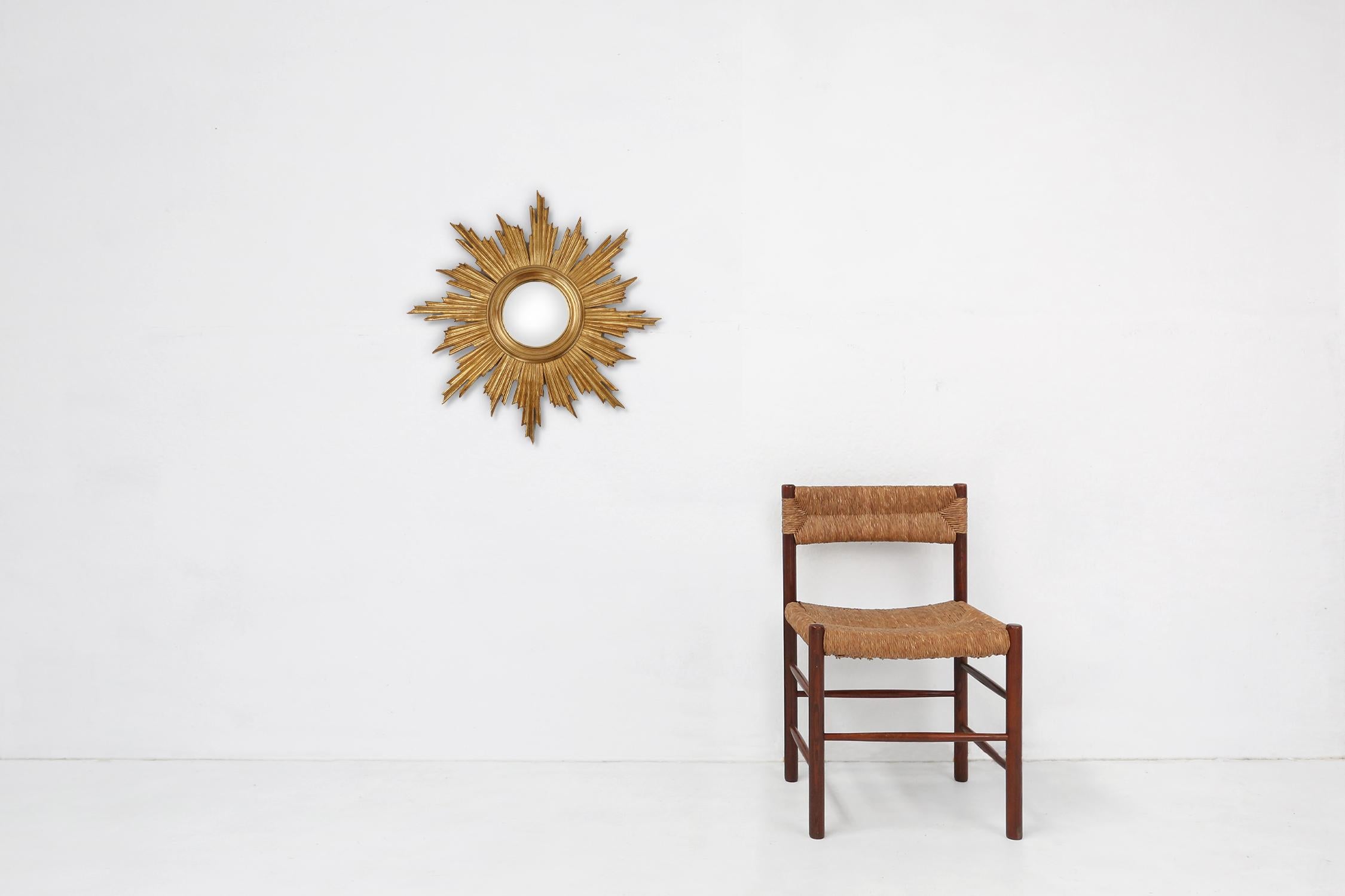 France / 1970 / sunburst mirror / gilded wood with convex mirror / mid-century / design / vintage

A beautiful sunburst wall mirror with classic convex mirror made in the 1970s in France. With gilt wooden frame and hanging system on the back. 

This