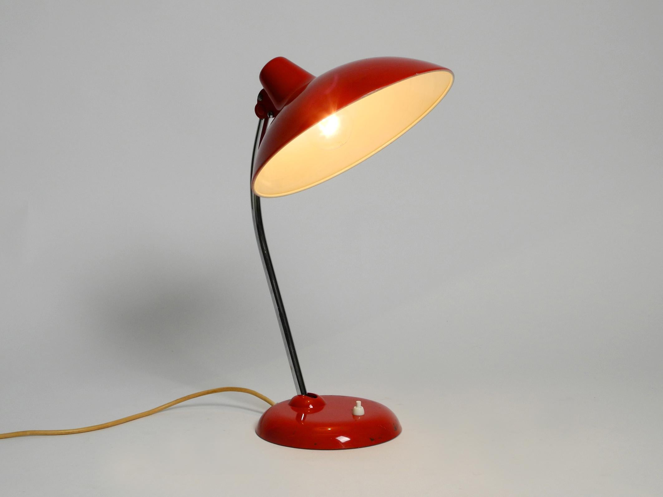 Classic red Kaiser Idell metal table lamp. Model 6786 from the 1960s
Fully functional and 100% original condition. Not refurbished condition with original paint.
No damage to the shade or base, no bumps or dents.
Just a few light scratches on the