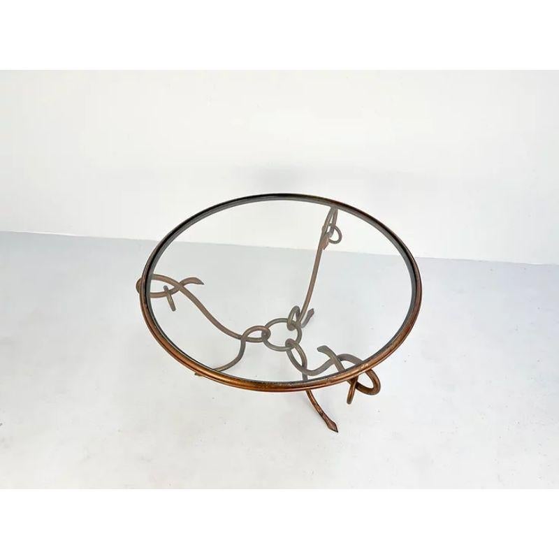 Original coffee table in gilded iron by René Drouet.

Round coffee table in wrought gilded iron. It was designed by René Drouet (1899–1993) in the 1940s in France. This table is in very good original condition with its original patina.