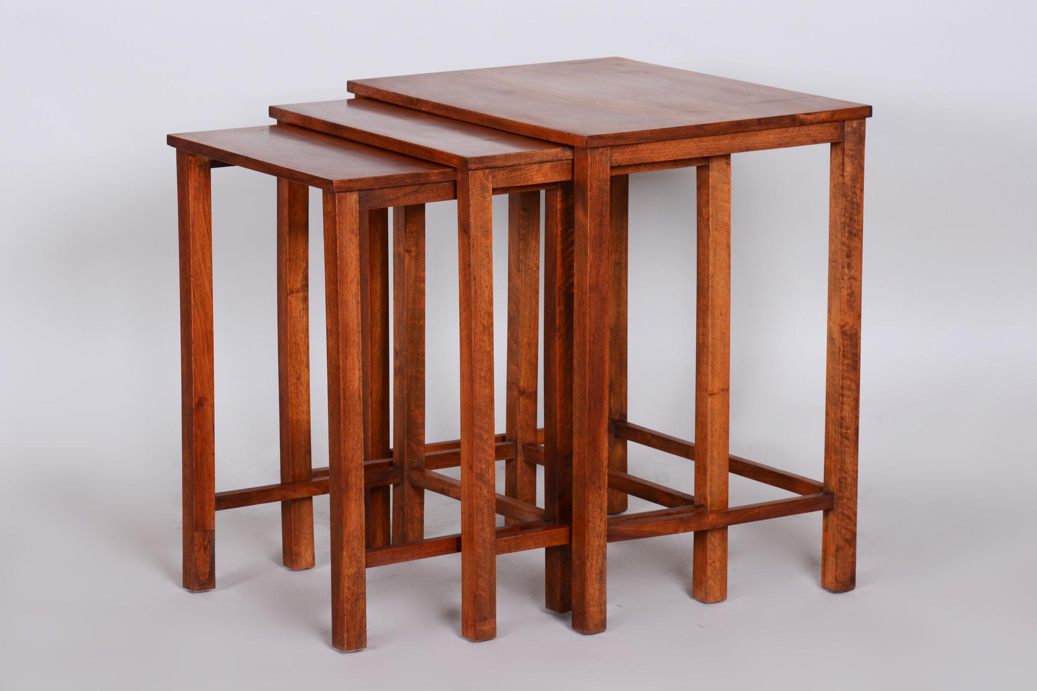 Beautiful brown nest tables made in the 1930s, they are made out of walnut.