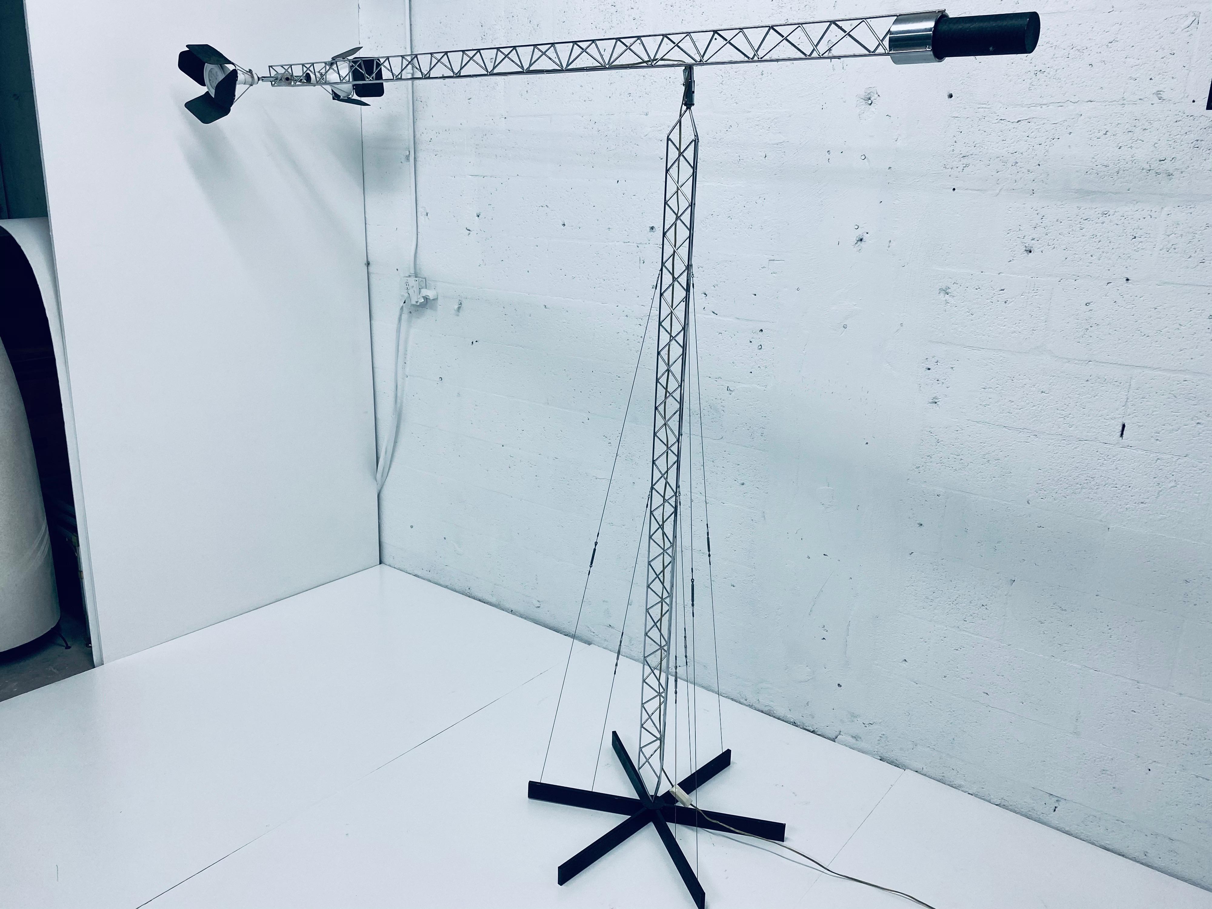 Large crane like chrome floor lamp designed by Curtis Jere from the 1970s. The lamp is adjustable up and down by utilizes a counter weight for stability and also swings 360 degrees. The spot lamps are also adjustable and can be pointed to the side