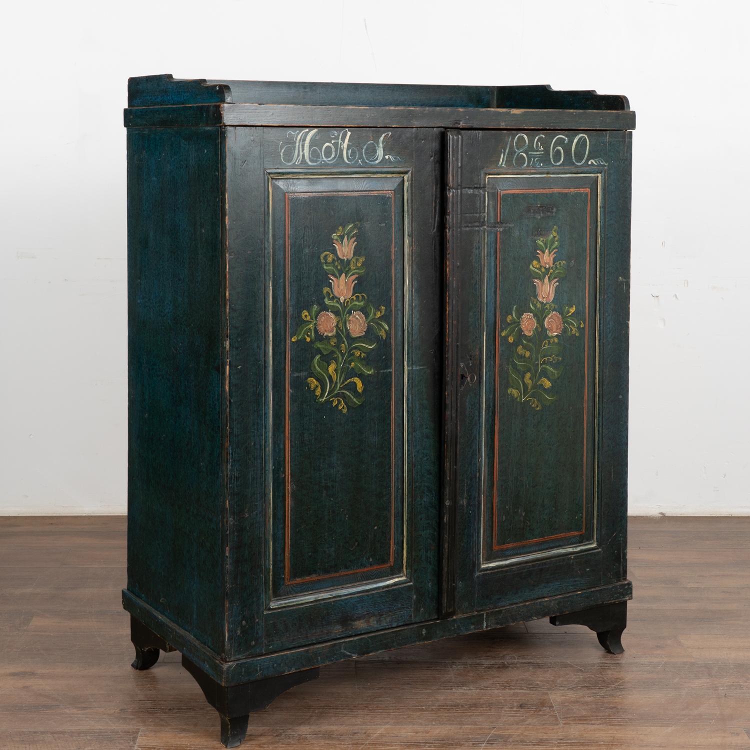 While you can frequently find original painted Swedish trunks, it is difficult to find a cabinet or sideboard with exceptional original folk art paint such as this one.
The two panel doors are painted with a traditional floral motif against a dark