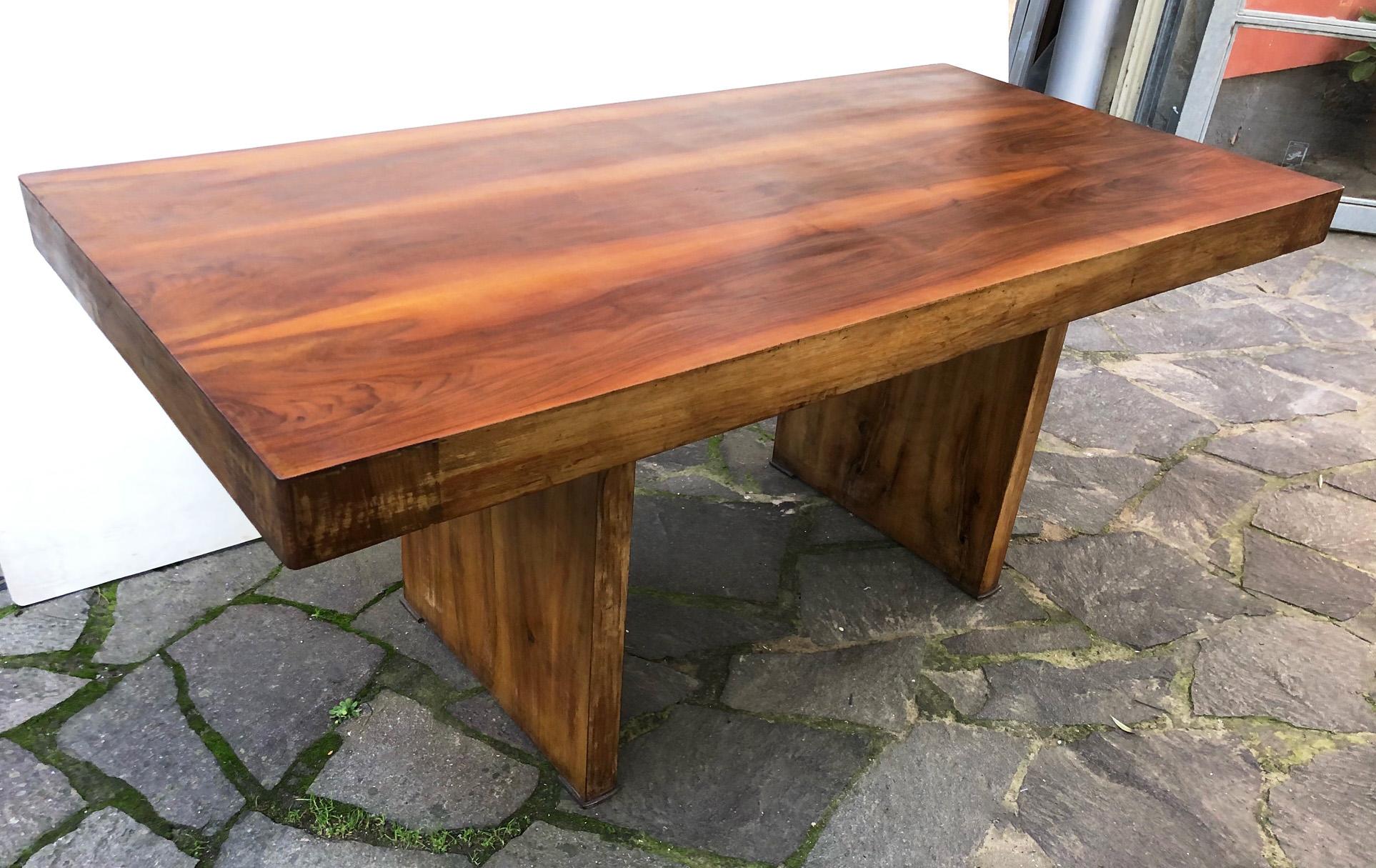 Original Italian table from 1940 in veneered national walnut. 
The top can be removed from the base.
Looking at the top against the light, you can see some sways due to the construction method made by sticking on transversal solid spruce