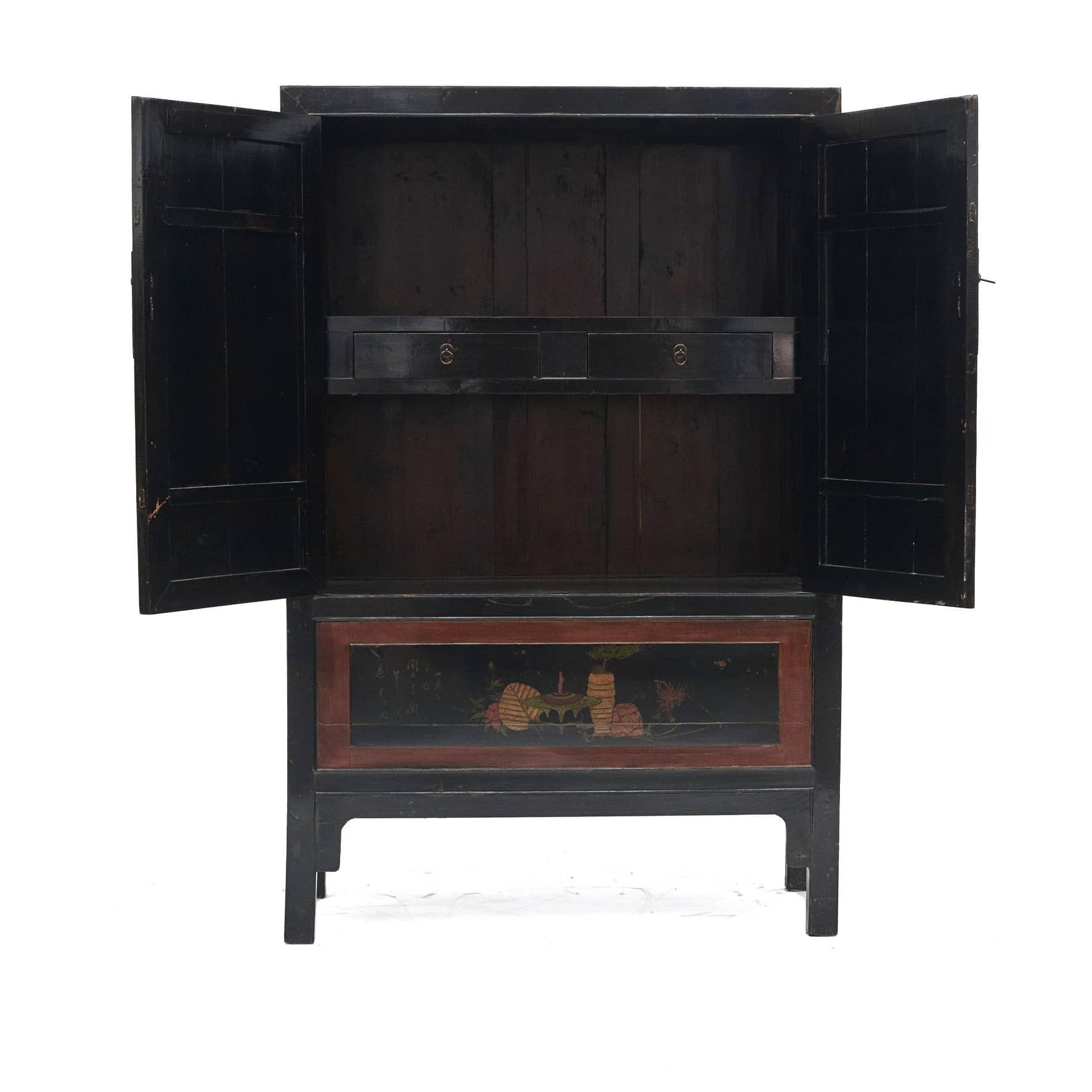 Original decorated cabinet, From Fujian Province 1860 - 1880.
Black lacquer base, frames with dark red lacquer.
Decorations in the form of flowers etc. in polychrome lacquer.
Pair of doors with rectangular metal fittings.

Behind doors, shelf