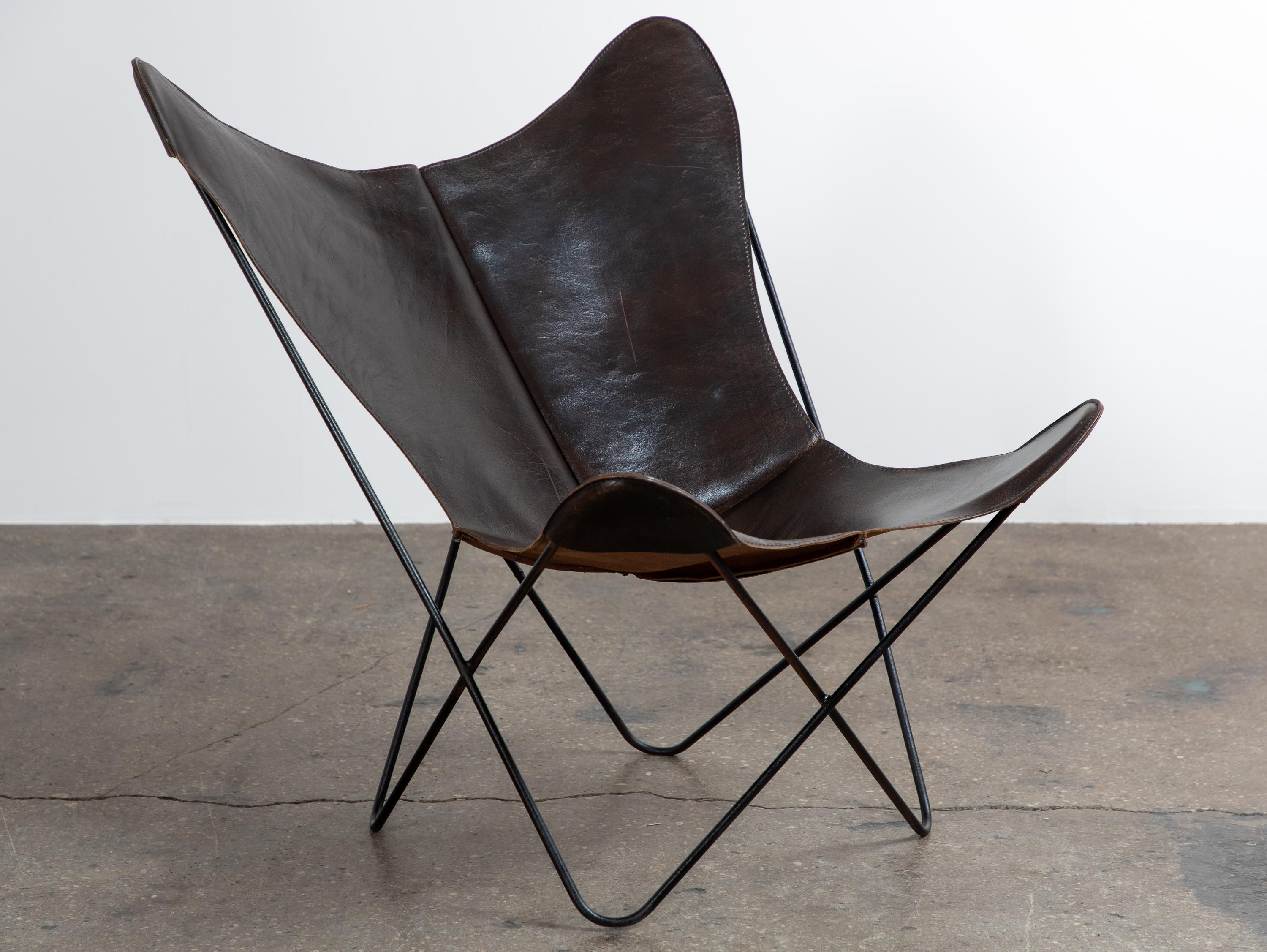Vintage Butterfly Chair with chocolate brown  leather sling, designed by Antonio Bonet, Juan Kurchan & Jorge Ferrari-Hardoy, issued by Knoll. An iconic mid-century design with a relaxed and rugged vibe. The chair's distinctive look comes from a