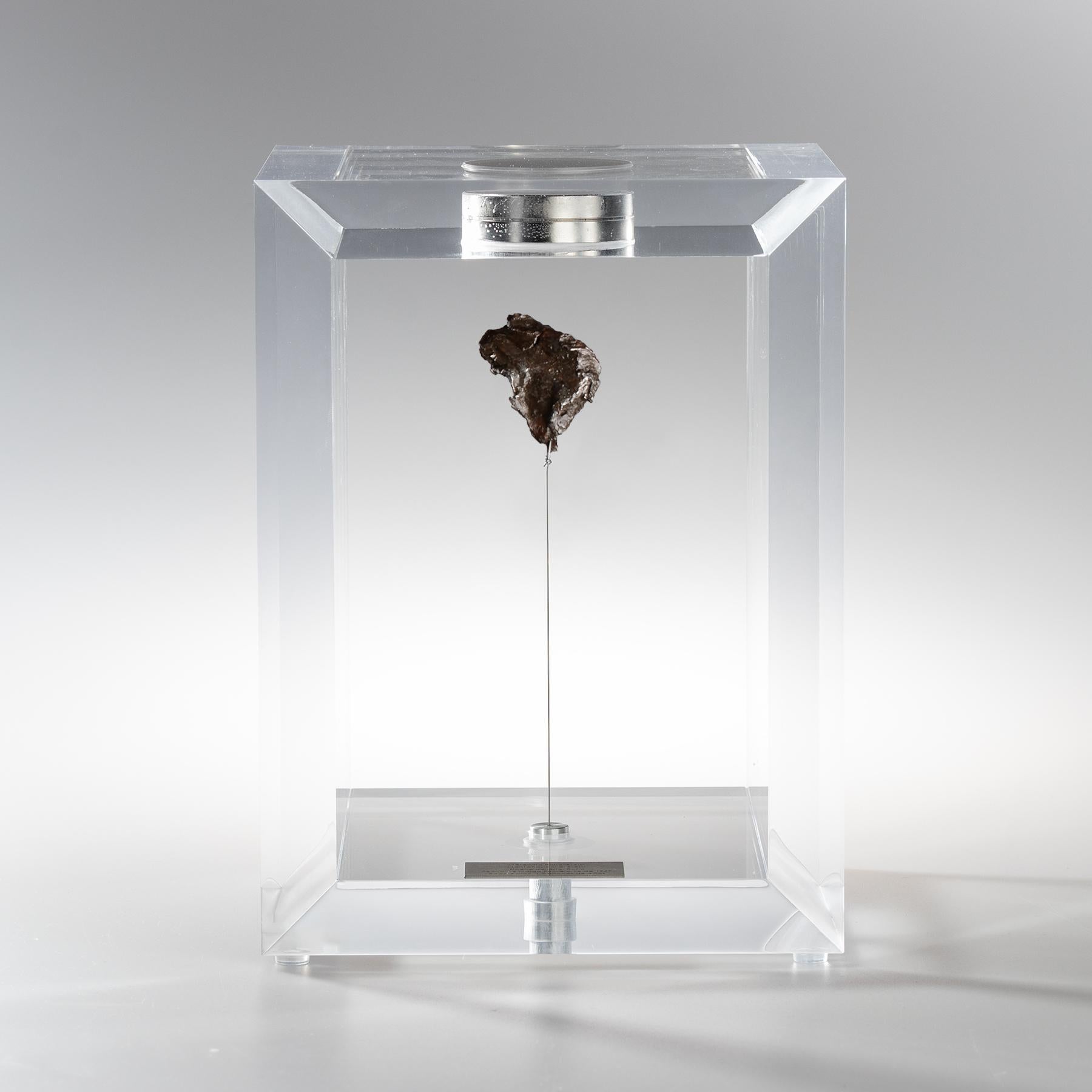 The “Space Box” was designed by Ernesto Duran, as a creative way to enhance the uniqueness of meteorites and could also be use as a decorative piece. Its an acrylic box with a magnet on top and a steel string pulling the Meteorite straight