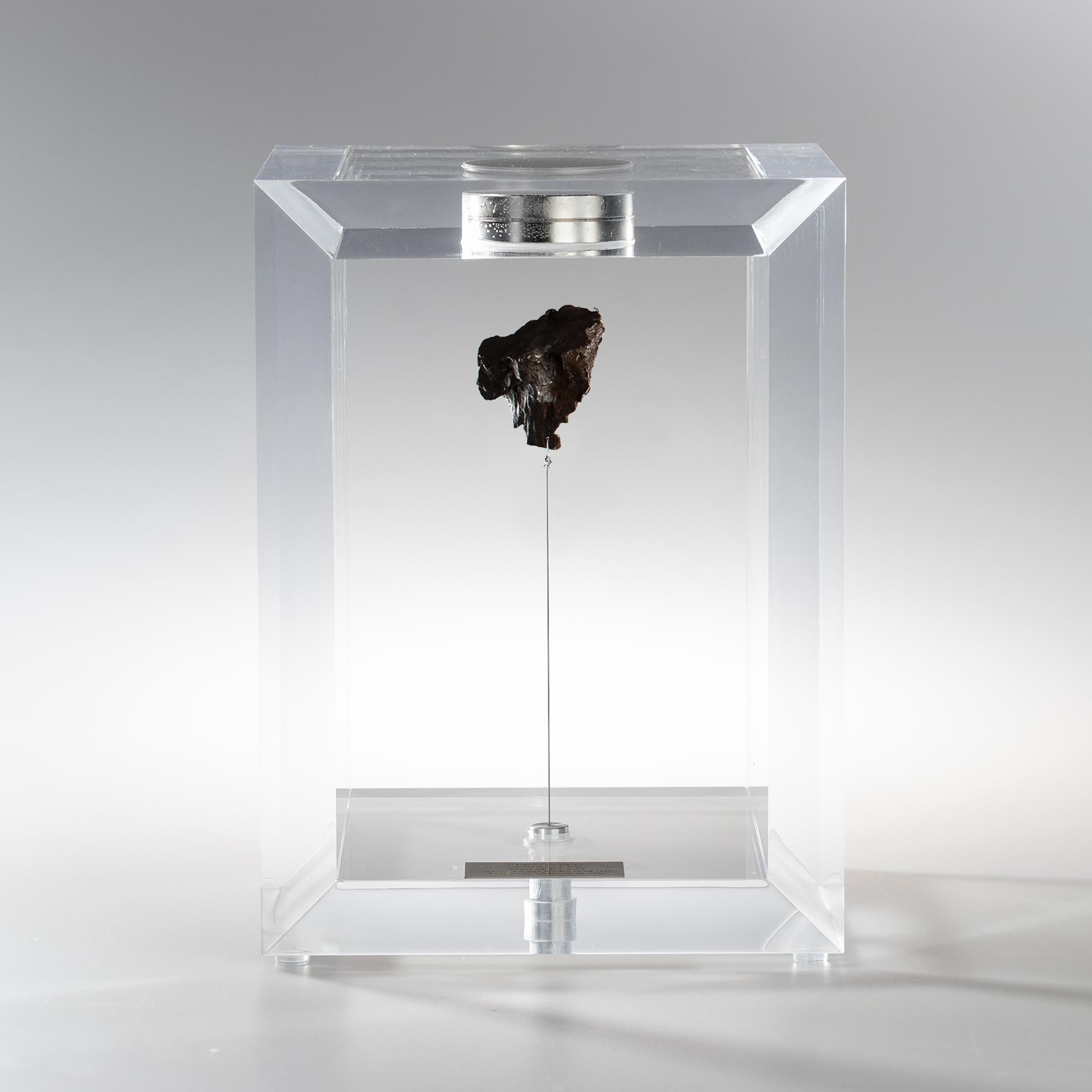 The “Space Box” was designed by Ernesto Duran, as a creative way to enhance the uniqueness of meteorites and could also be use as a decorative piece. Its an acrylic box with a magnet on top and a steel string pulling the Meteorite straight