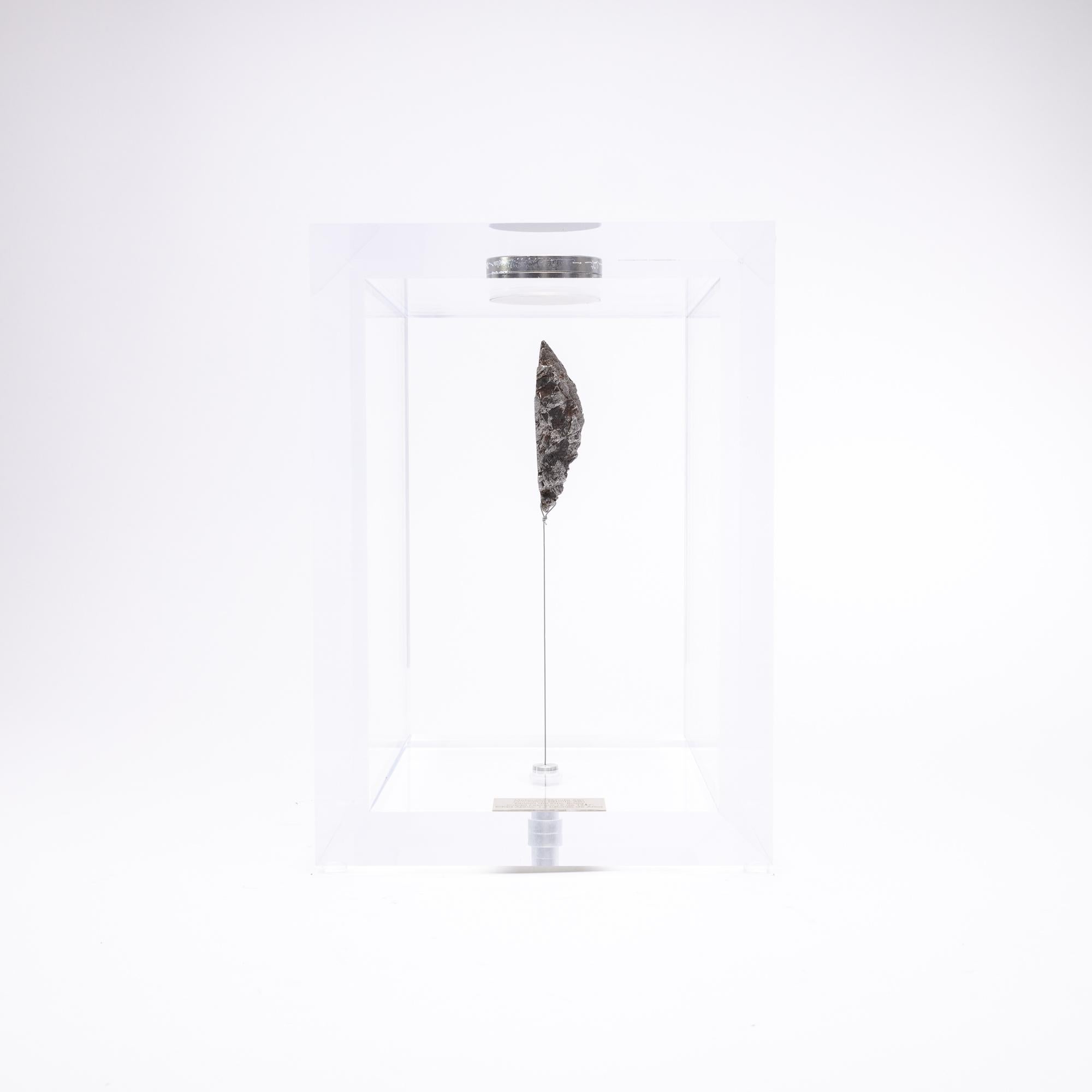 The “Space Box” was designed by Ernesto Duran, as a creative way to enhance the uniqueness of meteorites and could also be use as a decorative piece. Its an acrylic box with a magnet on top and a steel string pulling the meteorite straight