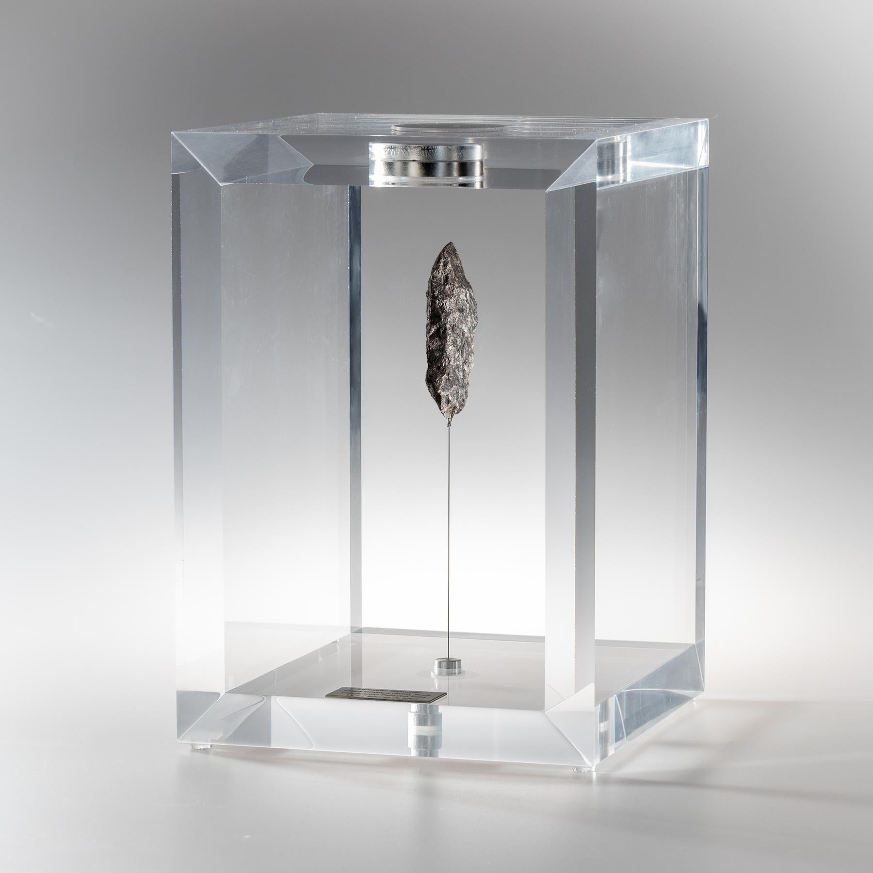 The “Space Box” was designed by Ernesto Duran, as a creative way to enhance the uniqueness of meteorites and could also be use as a decorative piece. Its an acrylic box with a magnet on top and a steel string pulling the meteorite straight