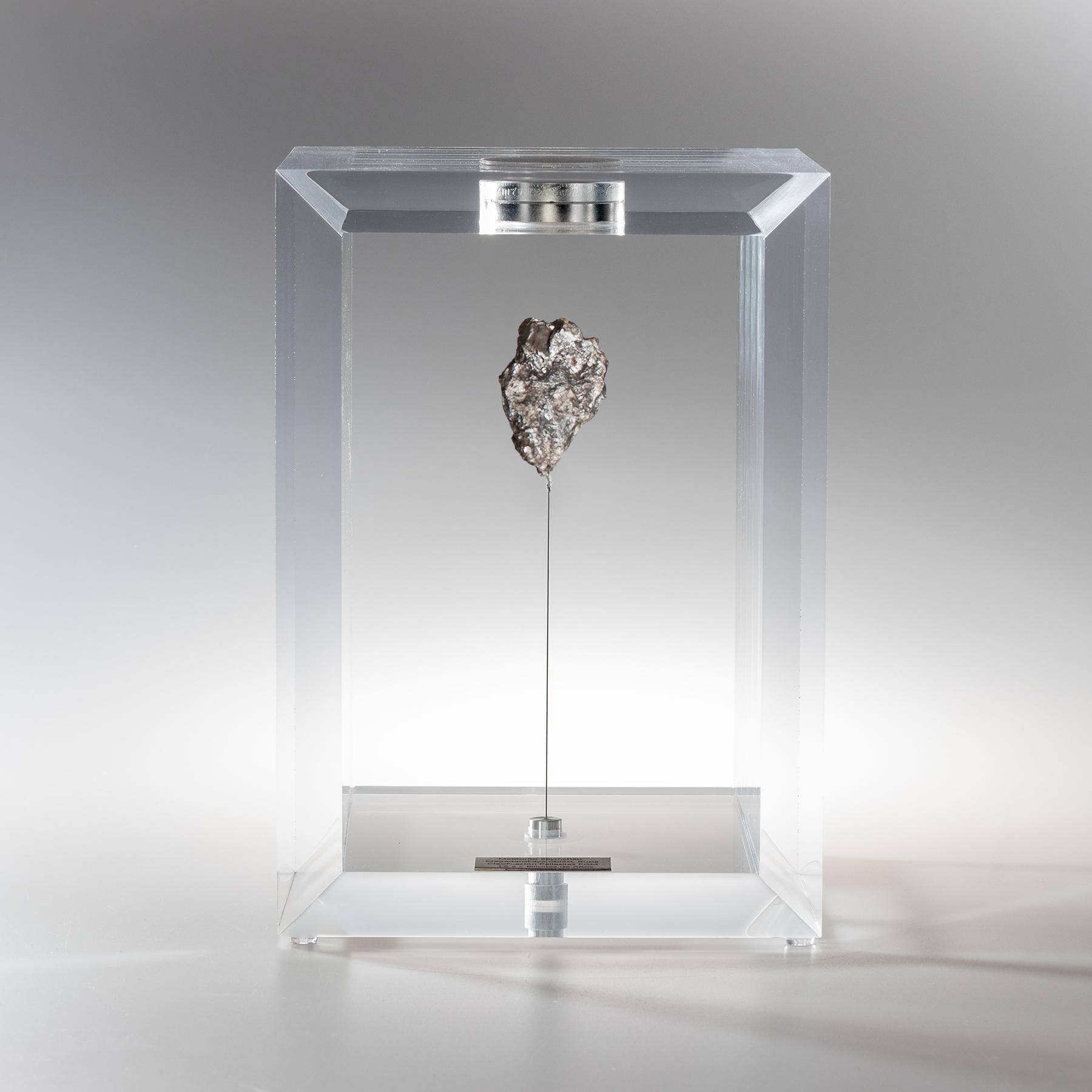 The “Space Box” was designed by Ernesto Duran, as a creative way to enhance the uniqueness of meteorites and could also be use as a decorative piece. Its an acrylic box with a magnet on top and a steel string pulling the meteorite straight
