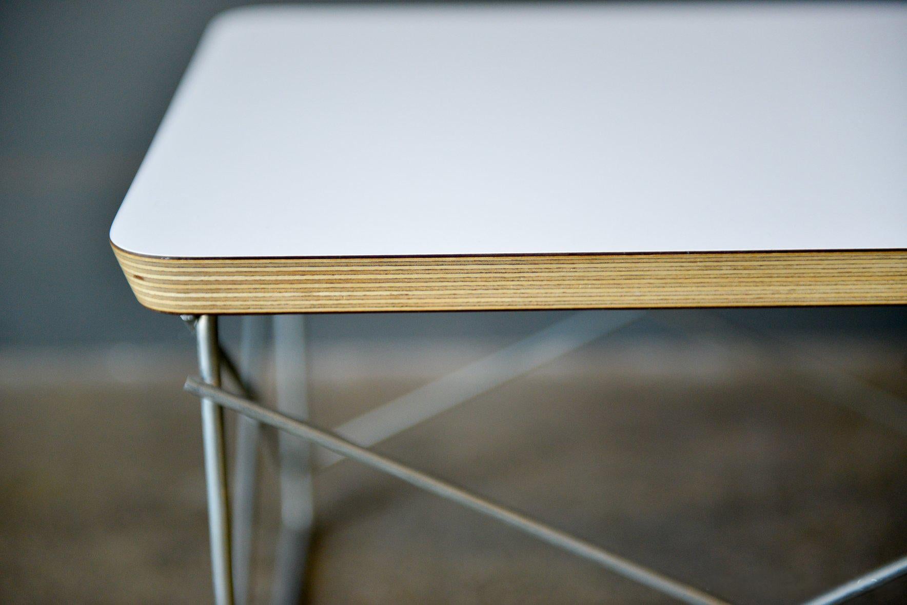 The LTR, or low table with rod base by Charles and Ray Eames for Herman Miller. A small side or occasional table with nice proportions and a lovely visual lightness due to the slender wire base. Solid core top and white laminate, or black laminate