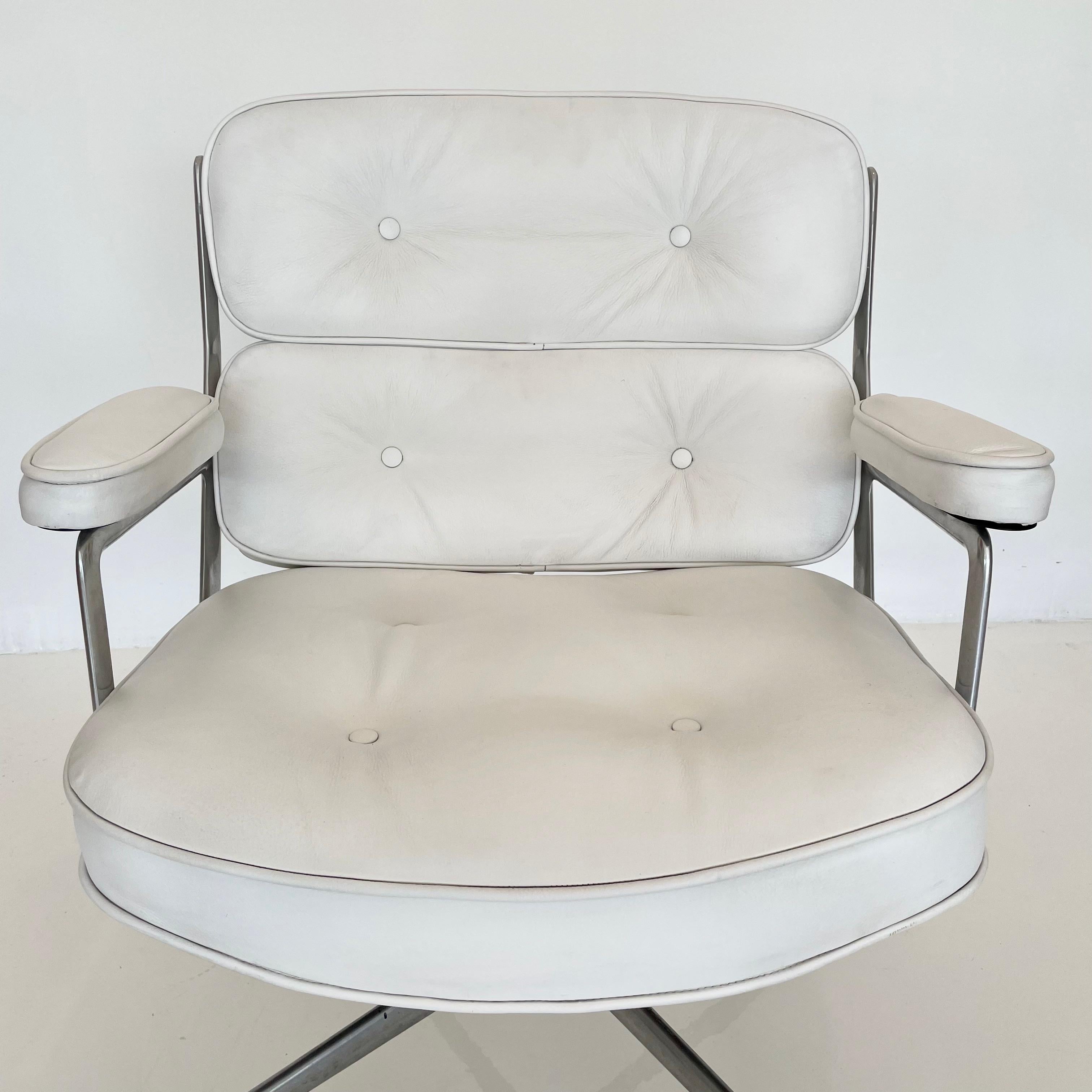 Classic Eames time life swivel chair in white leather. Unusual color. Chair swivels and reclines. Good vintage condition to metal and leather. Height adjustable with tilt back mechanism. Offered with original casters. The perfect vintage office