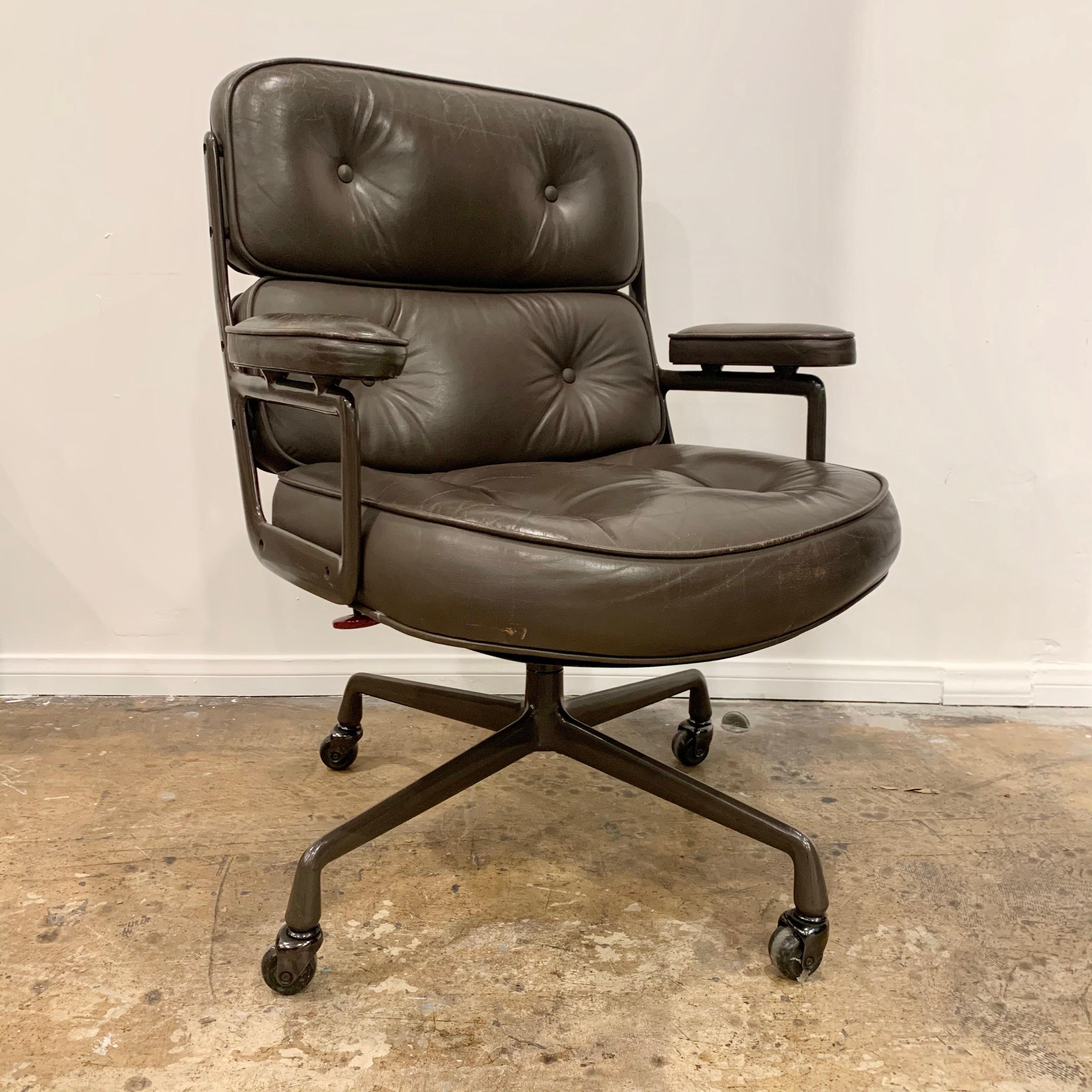 Eames time life swivel chair in dark brown/olive leather. Unusual color. Frame has been powder-coated in a matching dark brown color. Great color combination. Chair swivels and reclines. Good vintage condition. Height adjustable with tilt back