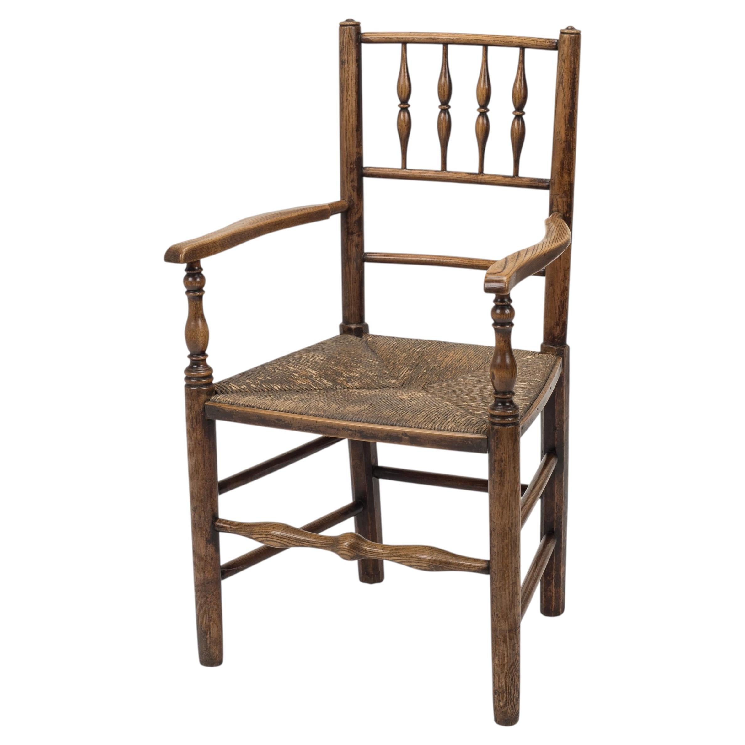 Fauteuil d'époque anglais de style campagnard, datant du début du XIXe siècle, en orme et frêne, avec assise en jonc