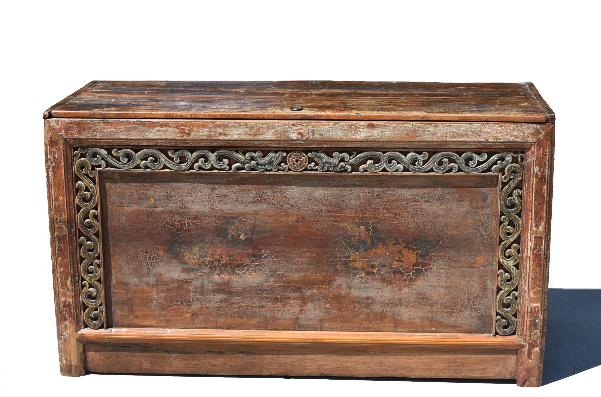 An all original, beautiful hand-painted chest, crafted by a master Mongolian artisan. Prominently featured is a pair of playful foo dogs, their curled manes and expressive eyes bringing life to the ancient imagery. Carved scrollwork weaves a