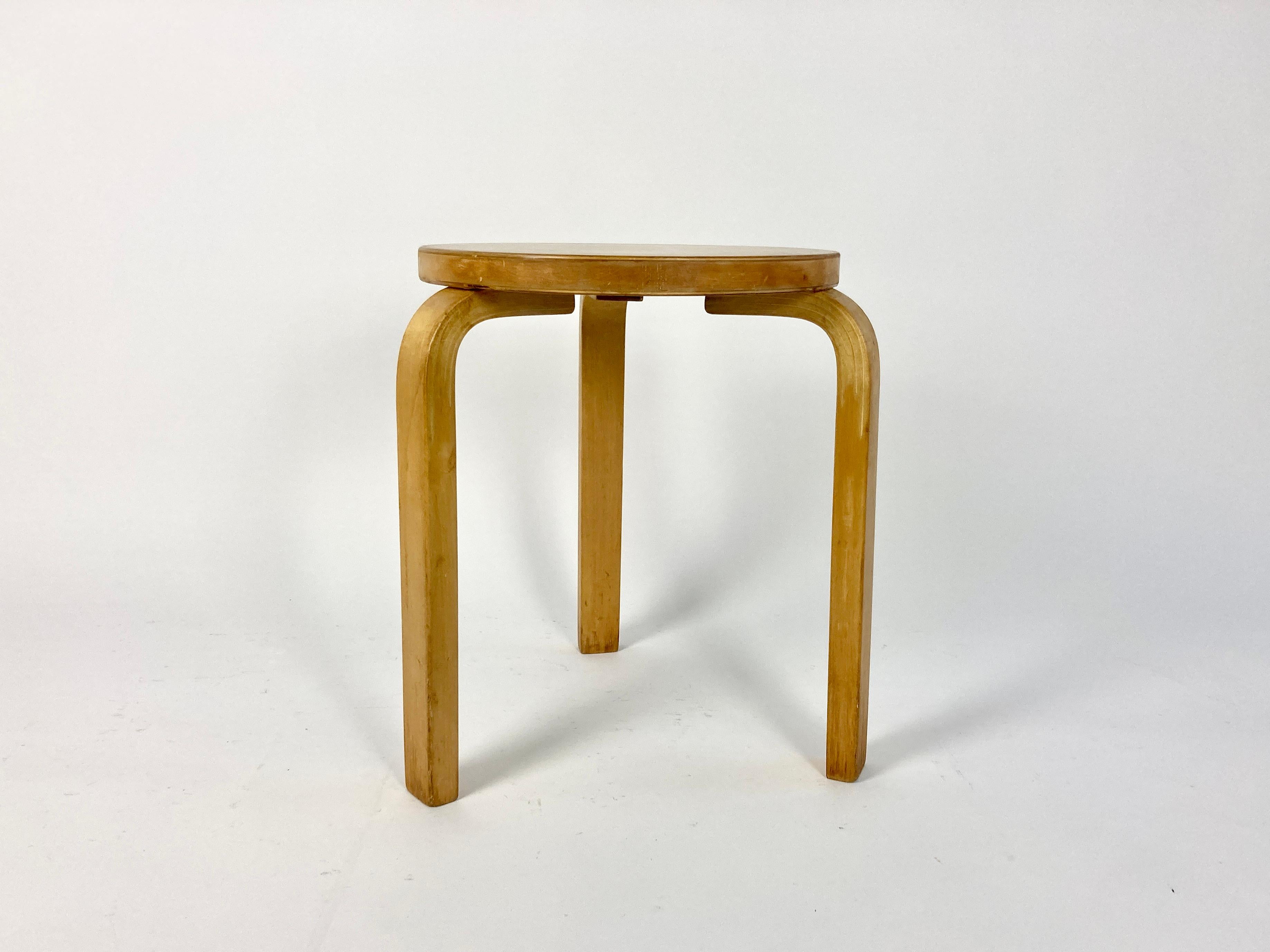 Early production 1930s/40s Model 60 stool designed by Alvar Aalto in 1934, made in Finland and distributed in the UK by Finmar.

Solid bent birch legs, sawn to create the bend. Birch seat with early production finger join to the veneer edge. Ivorine