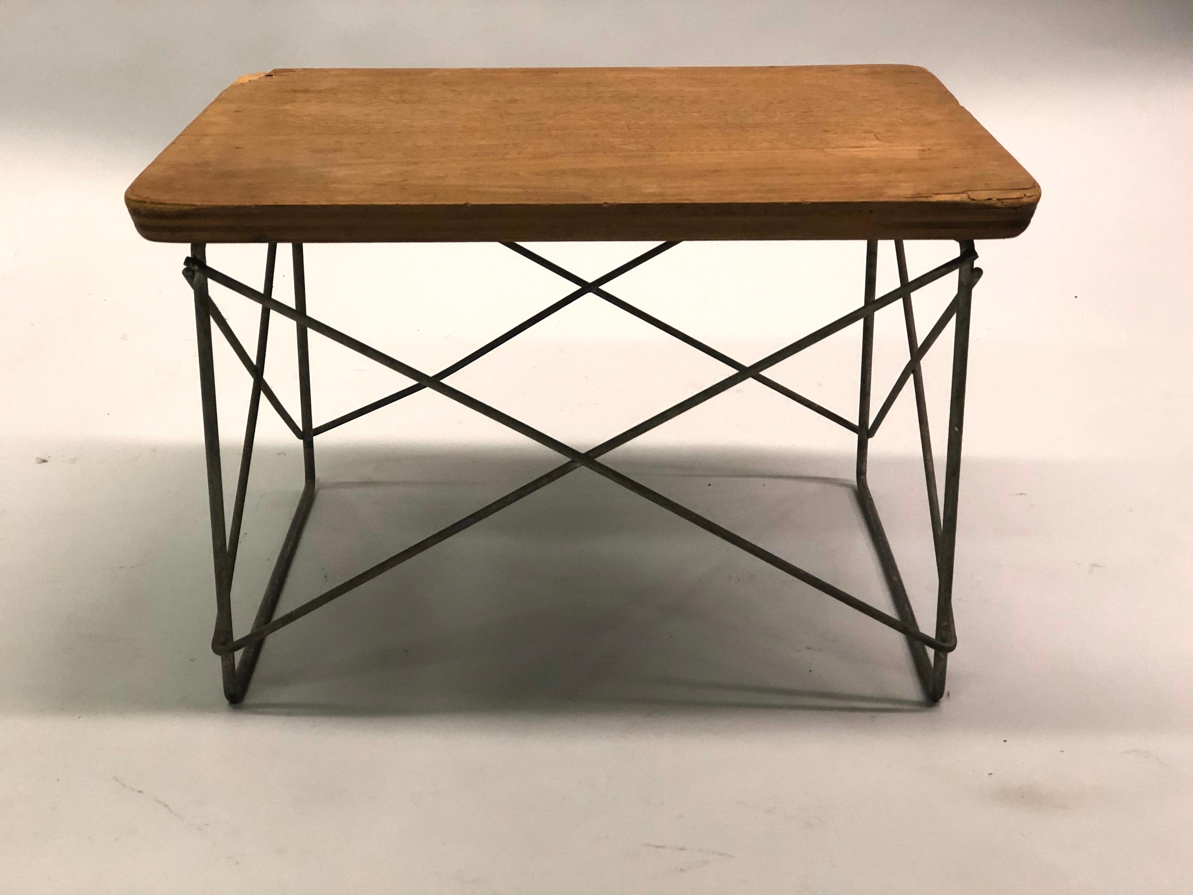An original and early production multifunctional LTR table, stool or bench by Charles and Ray Eames for Herman Miller composed of a zinc wire frame base and birch plywood top.