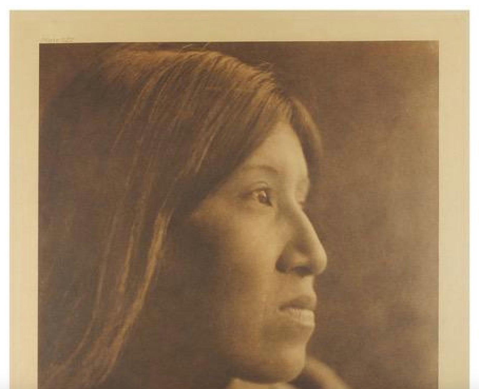 Presented is a fine photogravure portrait of a young woman of the Cahuilla tribe, from the deserts of Southern California. The image is Plate 522 from Volume 15 of Edward Curtis' epic project The North American Indian. The photogravure was published