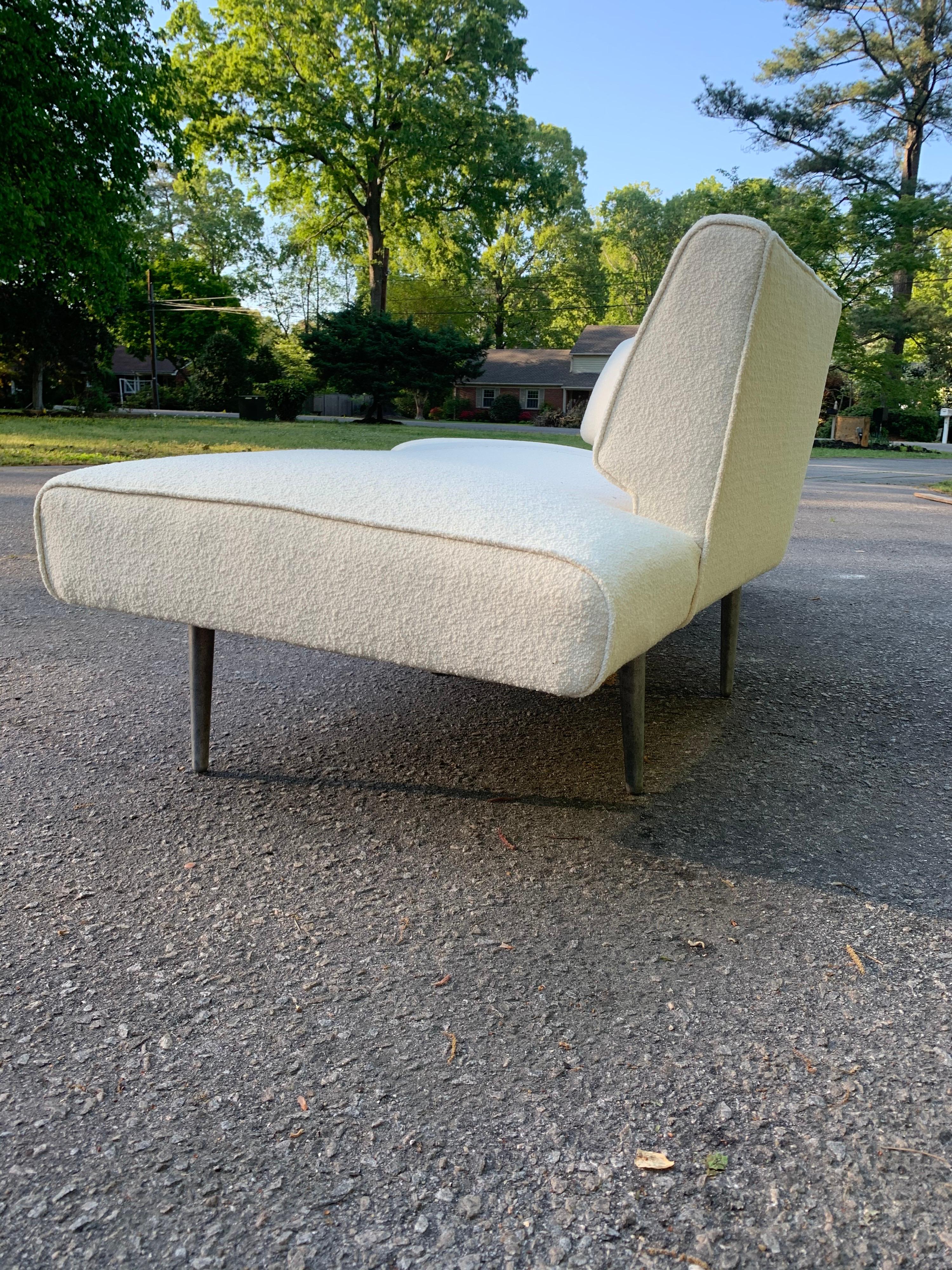 An original wing shaped sofa designed by Edward Wormley for Dunbar. Recently reupholstered in pearl Classic Boucle Knoll fabric. The sofa sits on 10