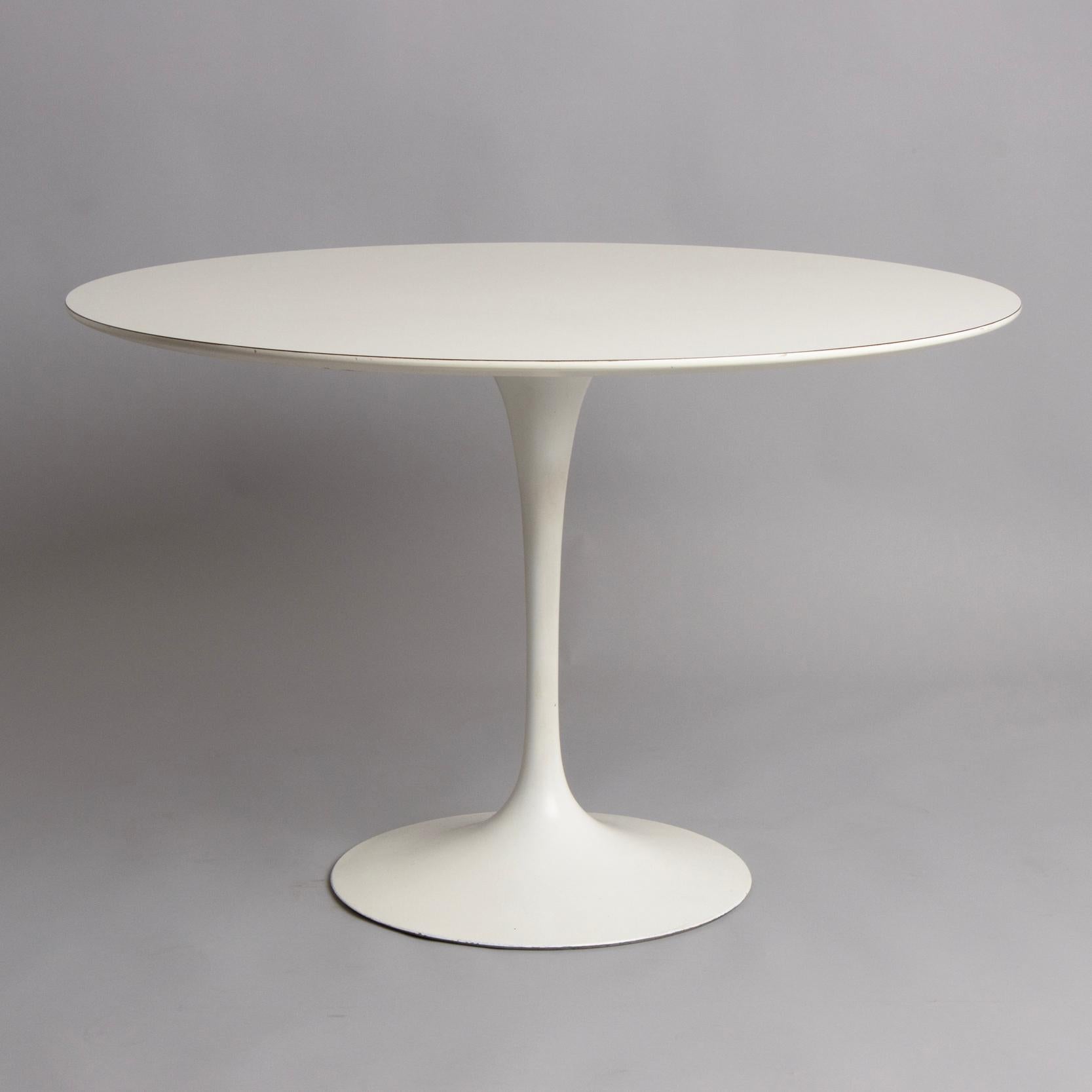 An original tulip table designed by Eero Saarinen and produced by Knoll International. The table has a laminate top and retains the maker's mark under the base. Excellent condition.